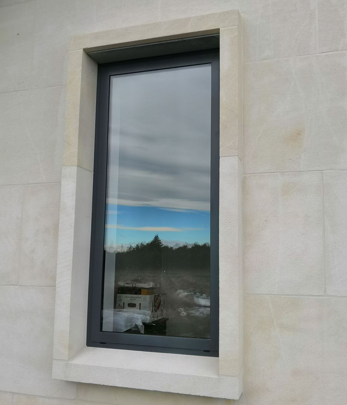 15degree limestone window sill with limestone window jambs and headers. Ōamaru stone.