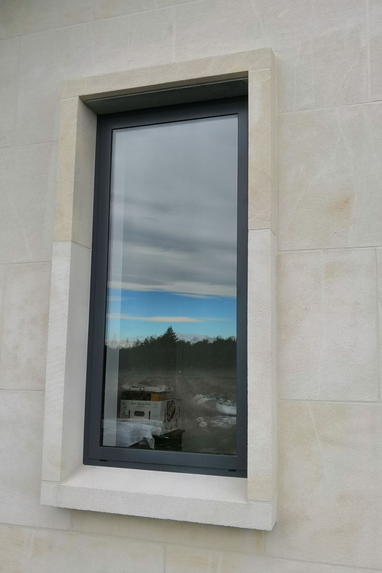 15degree limestone window sill with limestone window jambs and headers. Ōamaru stone.