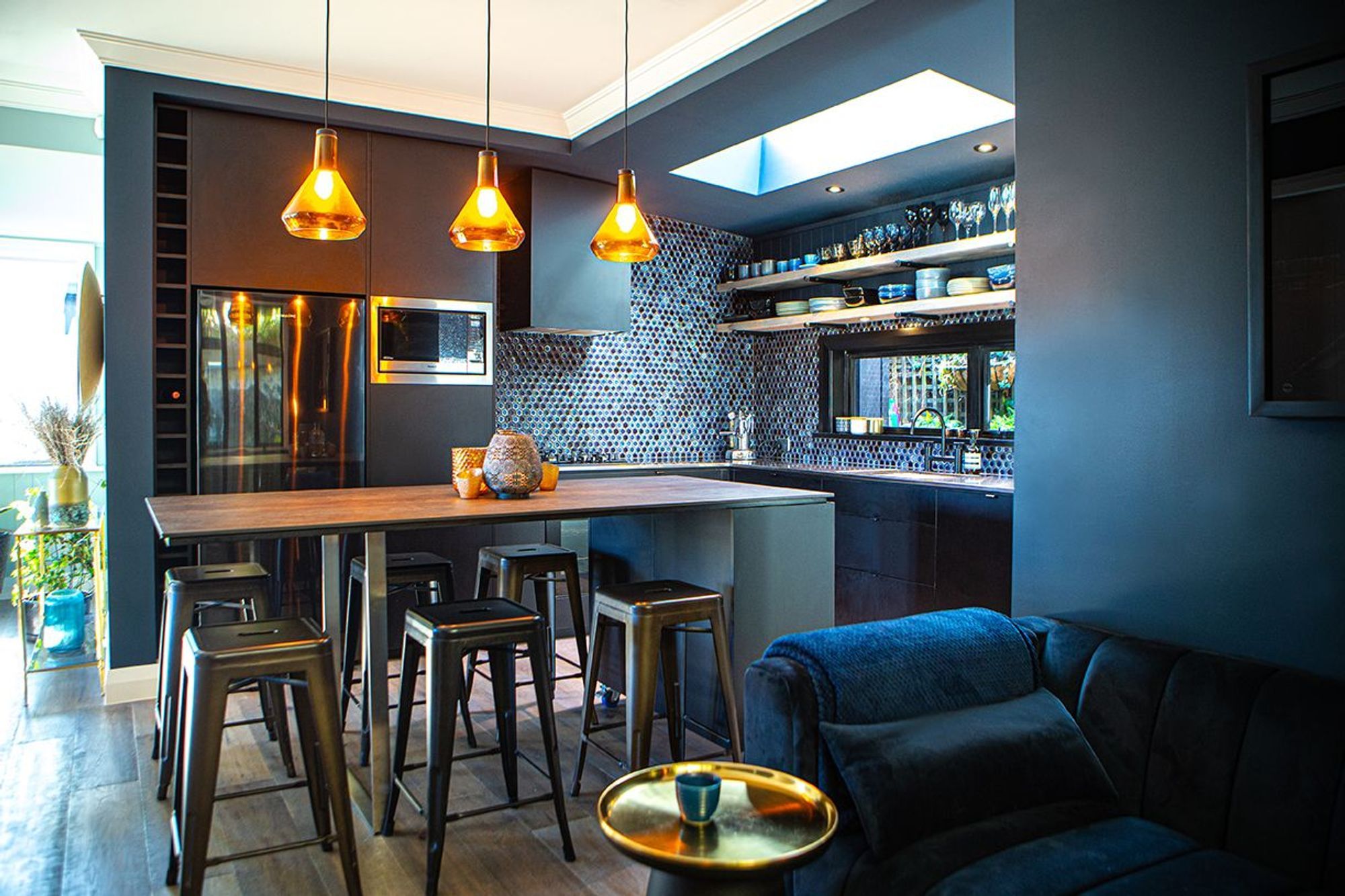 Moody tones in the kitchen design, splashback tiles and the adjacent sitting room.