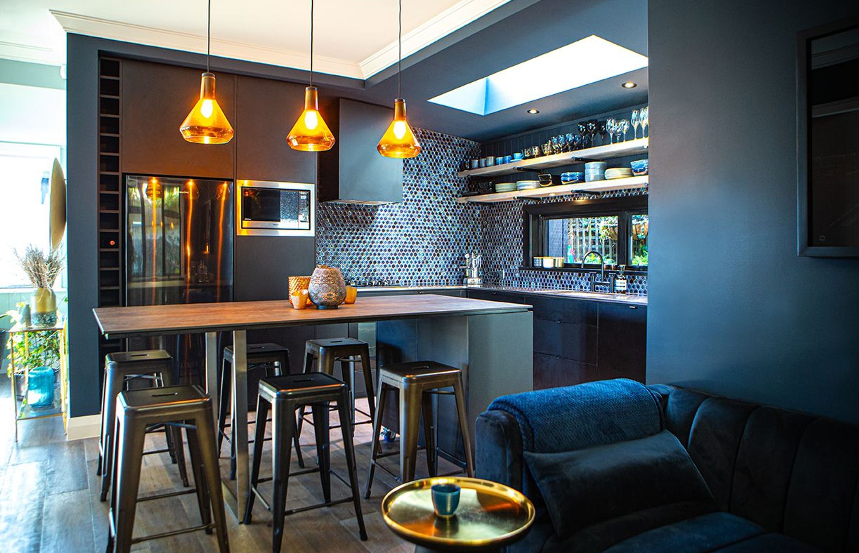 Moody tones in the kitchen design, splashback tiles and the adjacent sitting room.