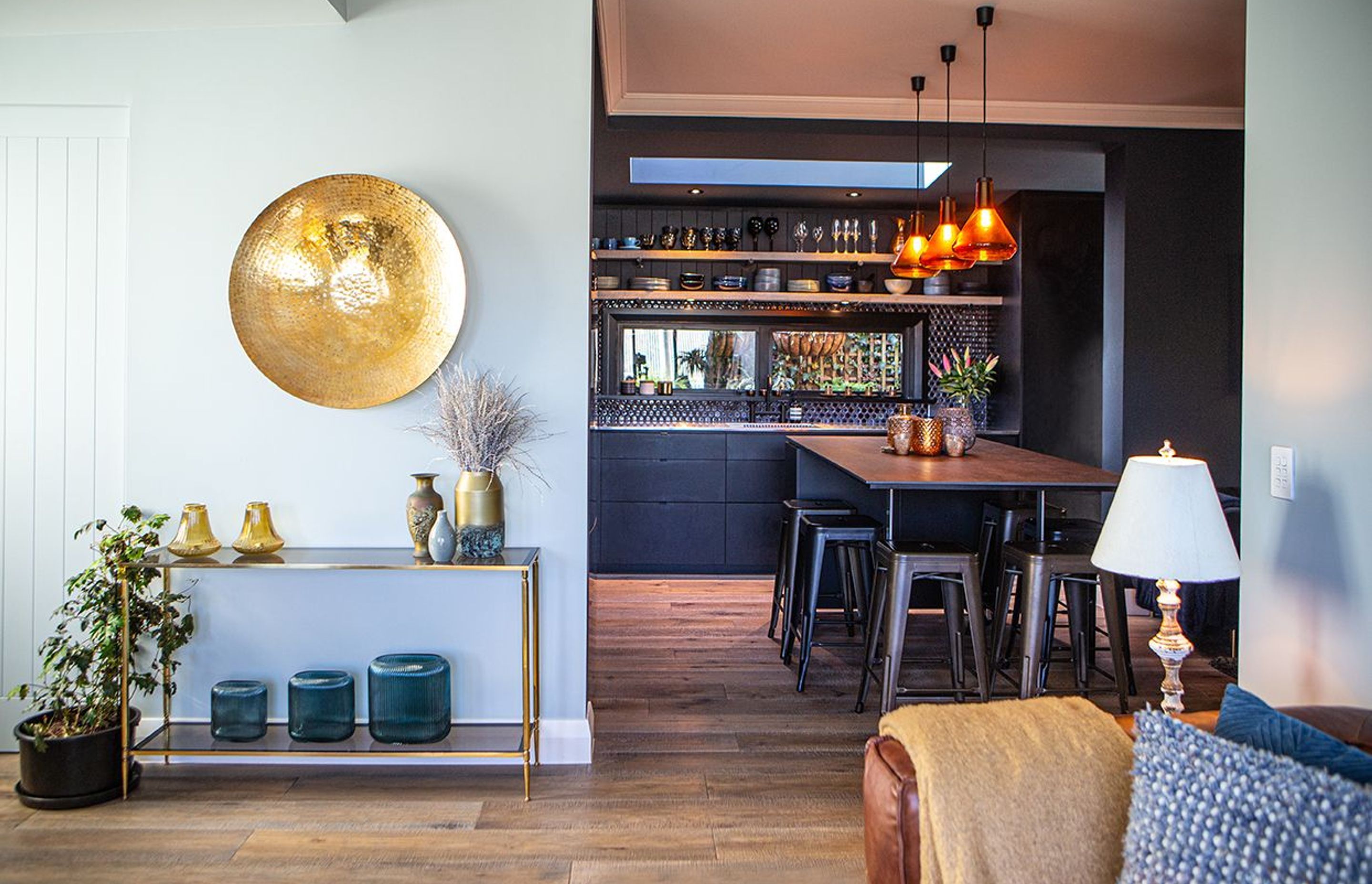 Light meets dark at the entrance to the kitchen design.