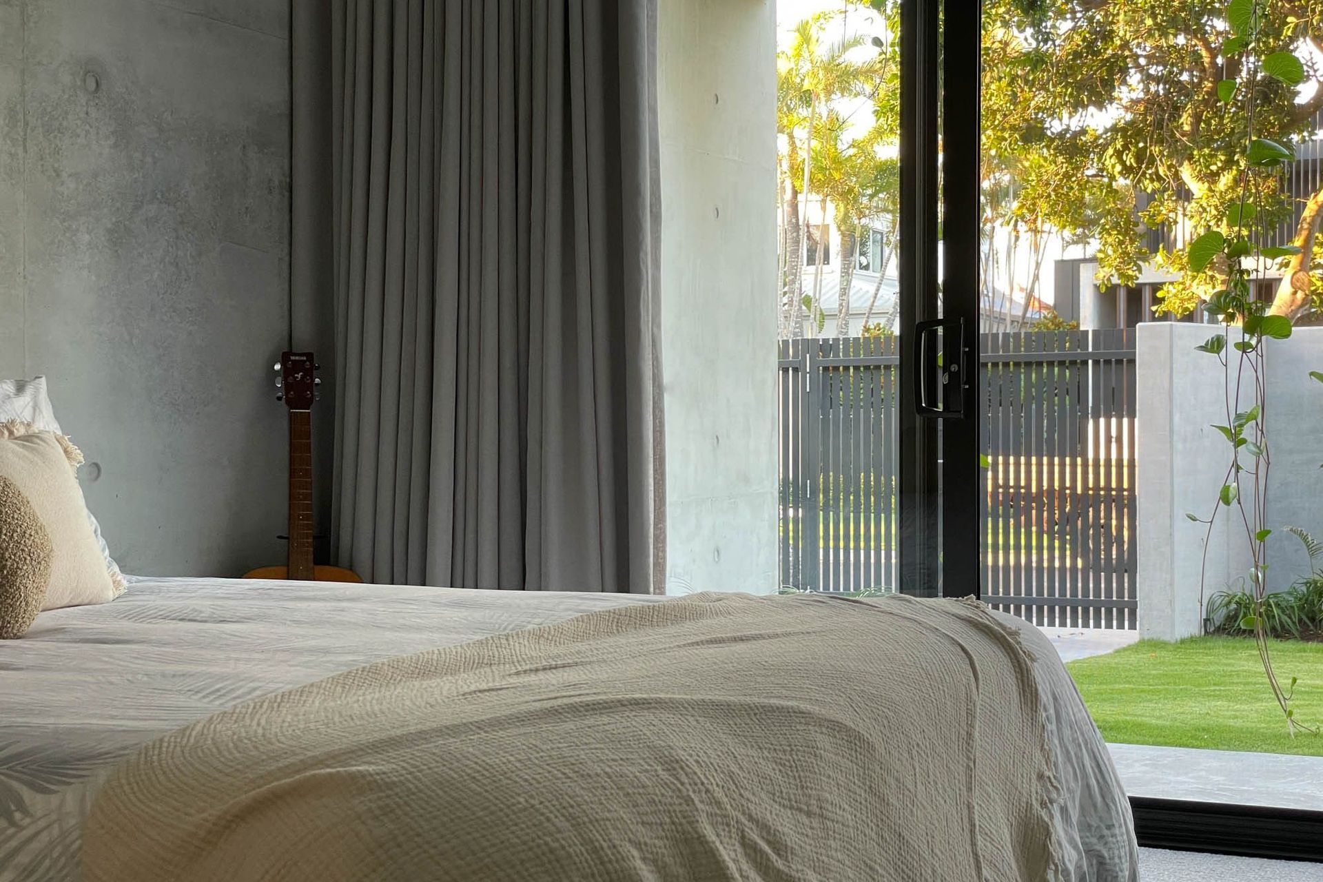 M Residence - Bedroom. Bedroom with sheer curtains and garden views.