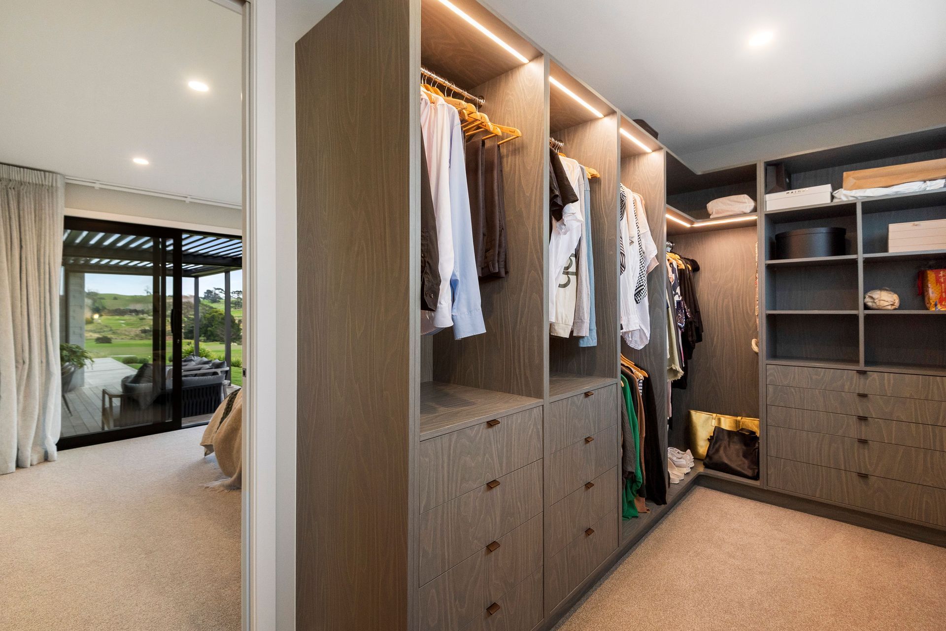 CUSTOM MASTER ROBE IN SMOKED BIRCHPLY WITH FEATURE LED LIGHTING