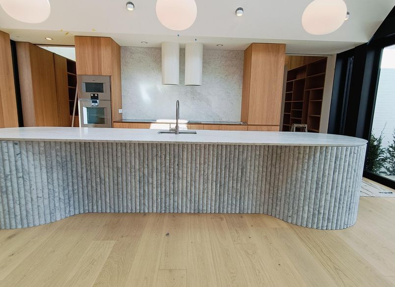 Damn Good Tiling - kitchen island flute marble tile