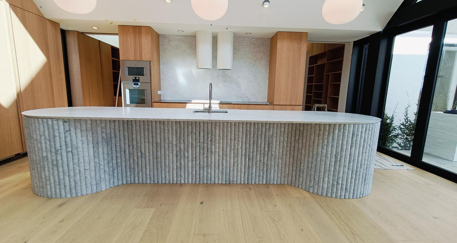 Damn Good Tiling - kitchen island flute marble tile banner