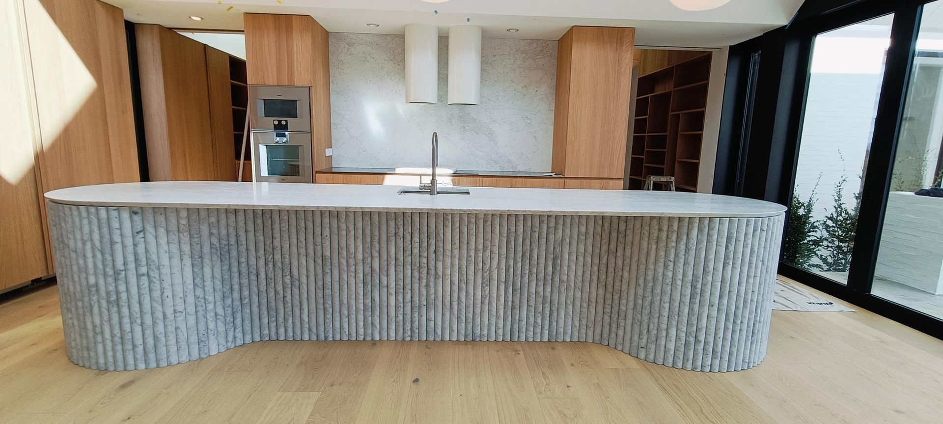 Damn Good Tiling - kitchen island flute marble tile banner