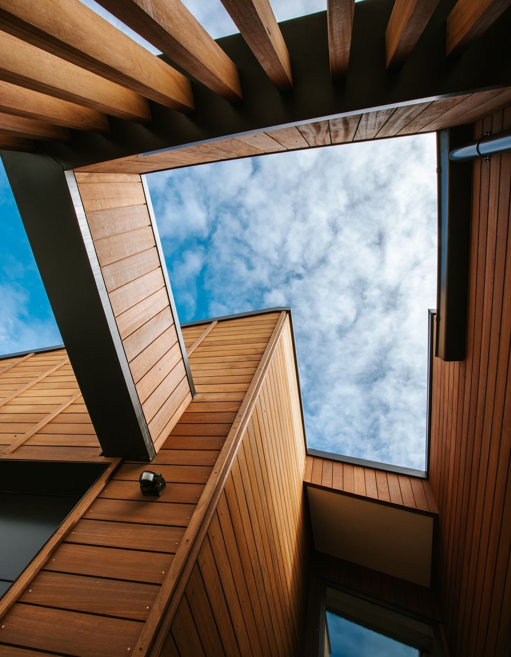 The cut-out detailing above the external courtyards delineates the outdoor spaces and provides an interesting architectural  detail.