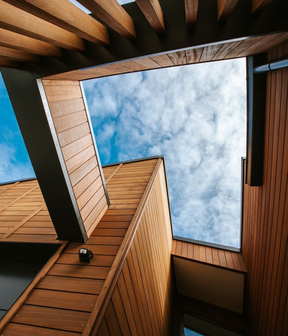 The cut-out detailing above the external courtyards delineates the outdoor spaces and provides an interesting architectural  detail.