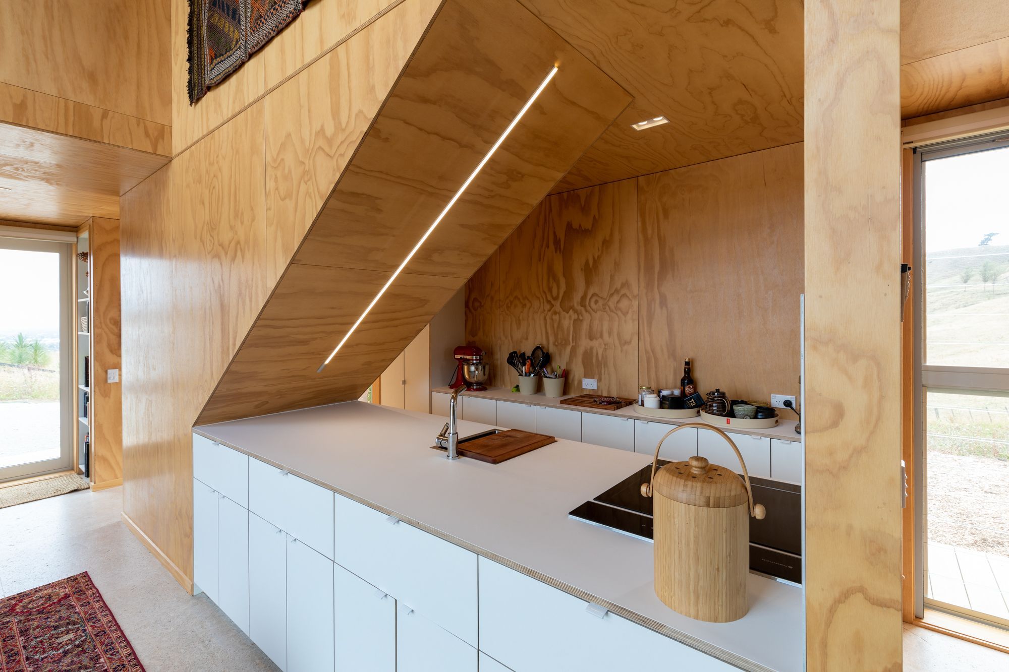 Despite a small footprint, custom cabinetry ensures a highly functional space.