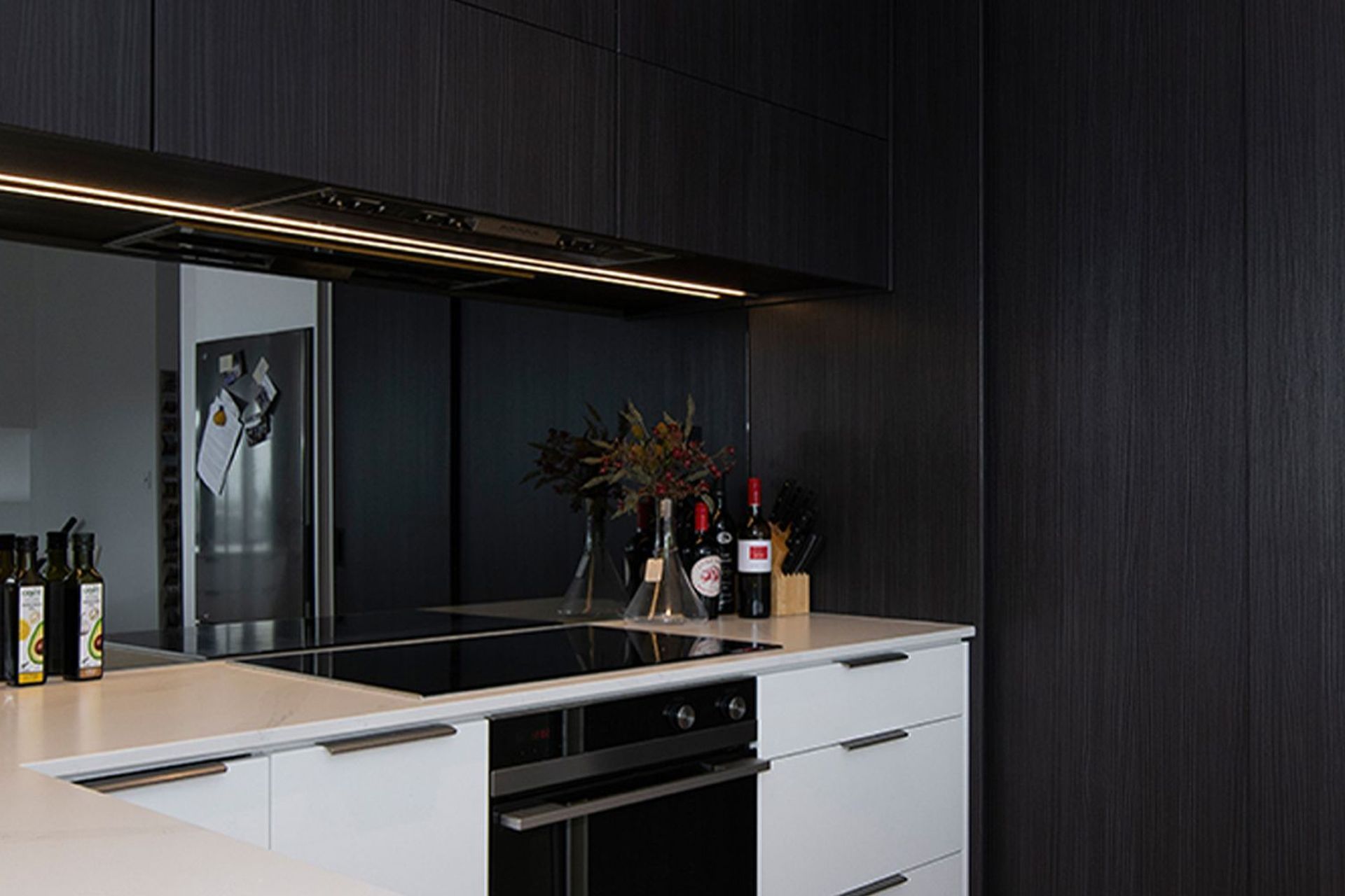 Milan profile in Hacienda Black - Woodgrain. Design by Modern Kitchens. Photography by Liam Dijk.
