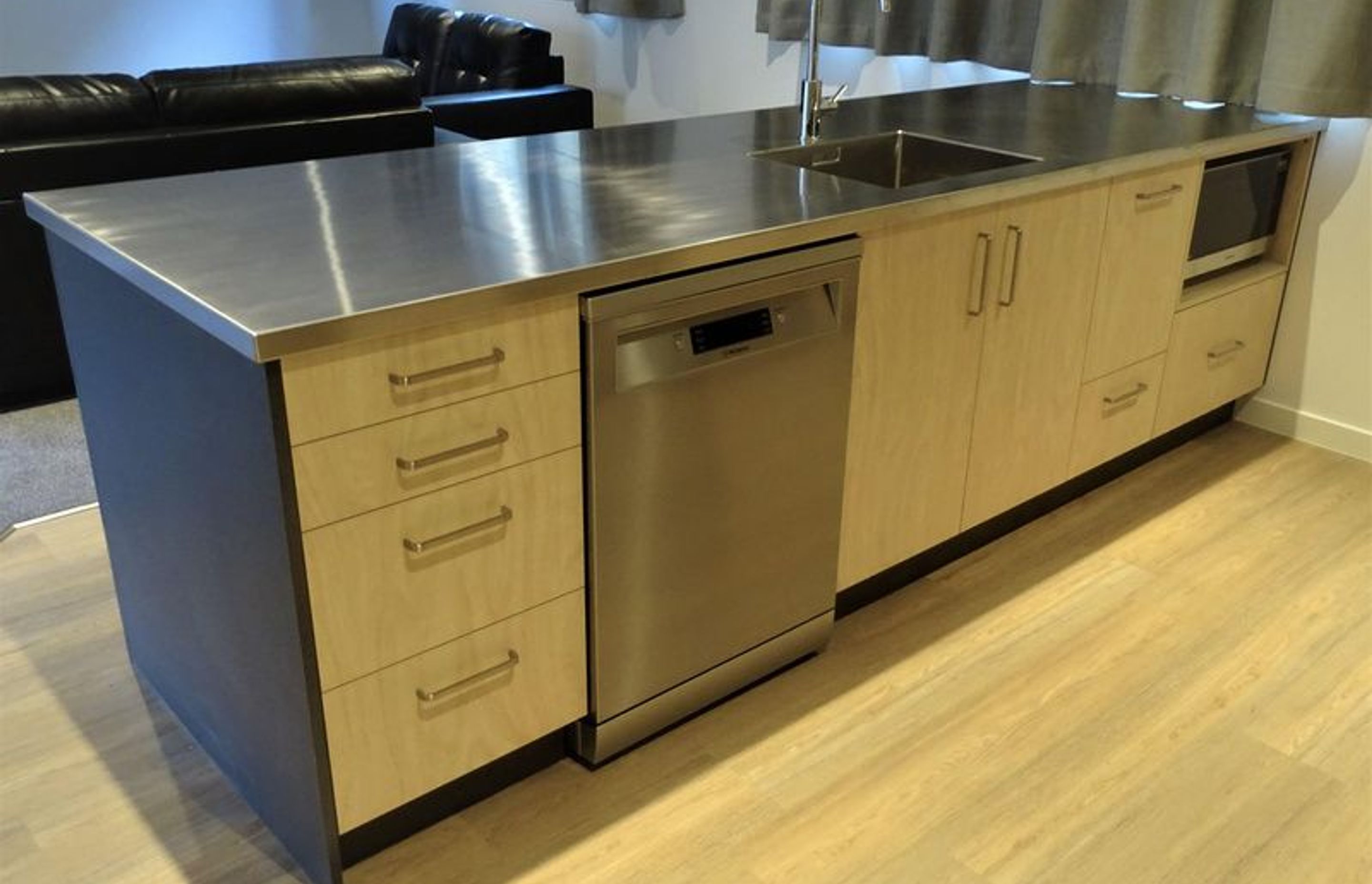 Kitchen cabinetry dishwasher and microwave built into the kitchen island