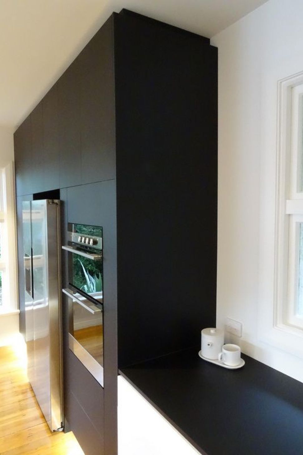 The kitchen cabinetry merges into the bench top