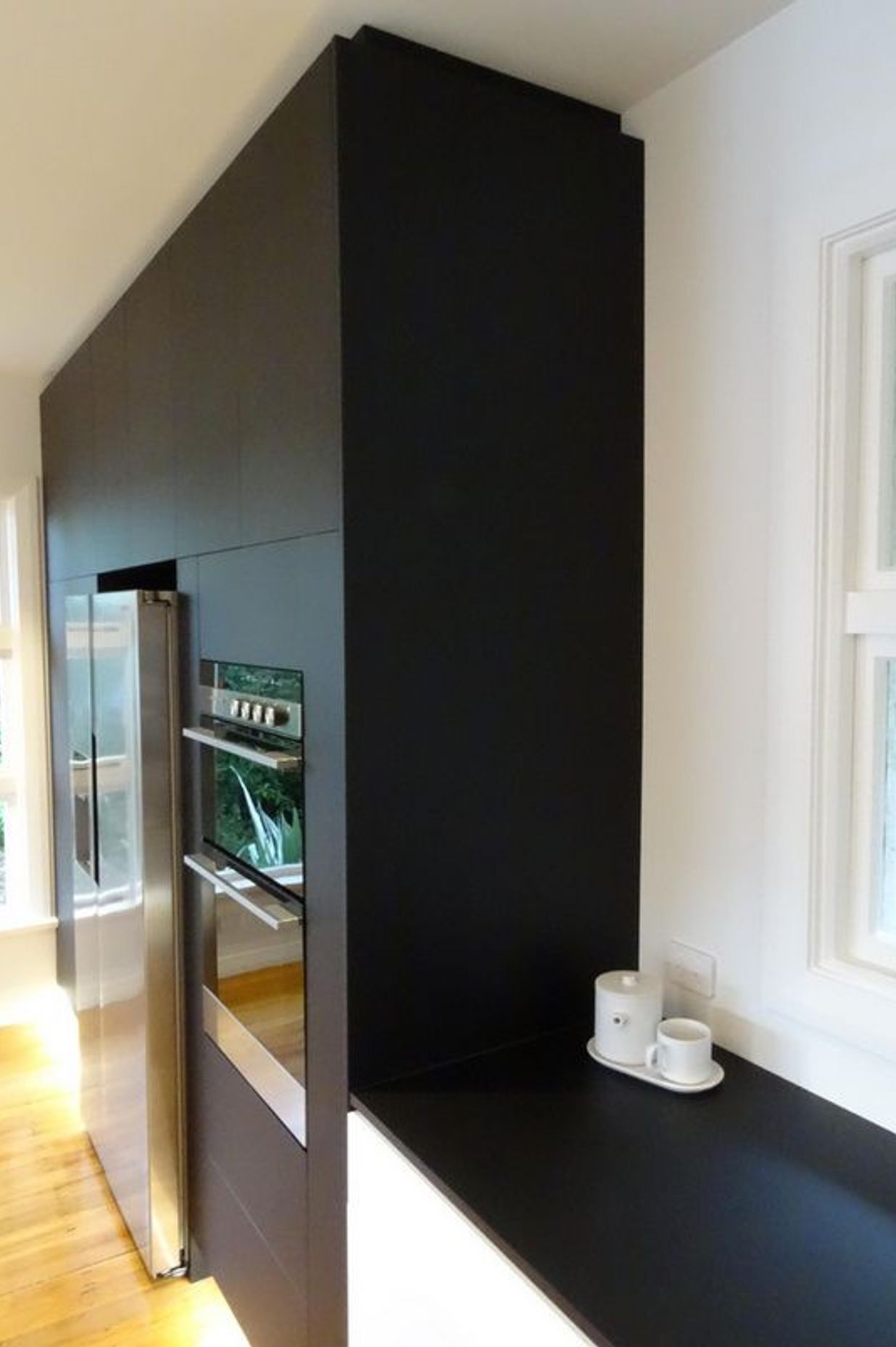 The kitchen cabinetry merges into the bench top