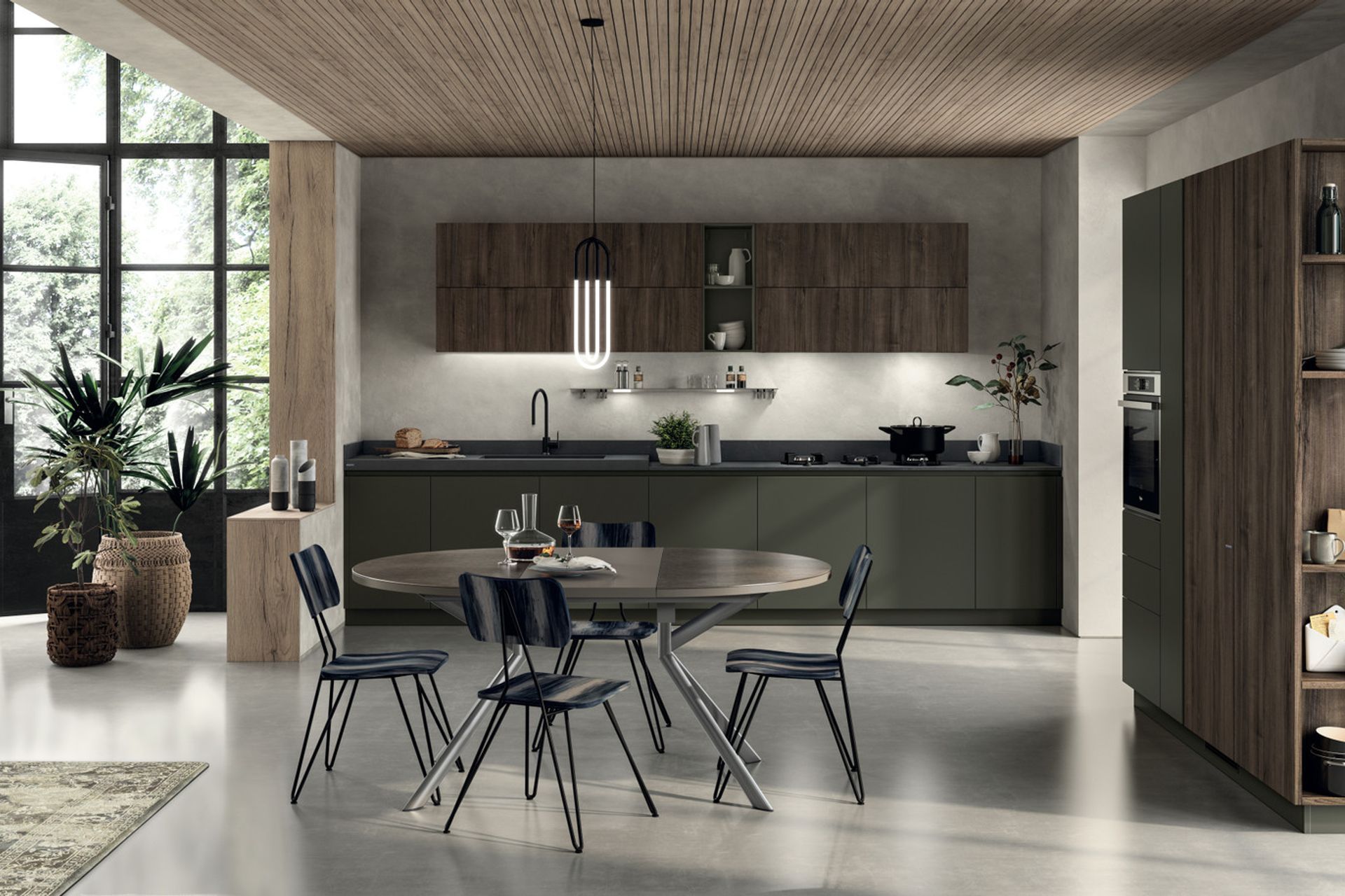 The harmonious appeal of Mineral Green used for the recessed grip profles, base units and plinths constitutes an extremely classy detail: this matt lacquered colour distinguishes the operational areas of the kitchen, and matches the textured feel of Calce Nero Porcelain Stoneware to perfection. The wall units and tall units are in Garden Walnut decorative melamine (with vertical grain).