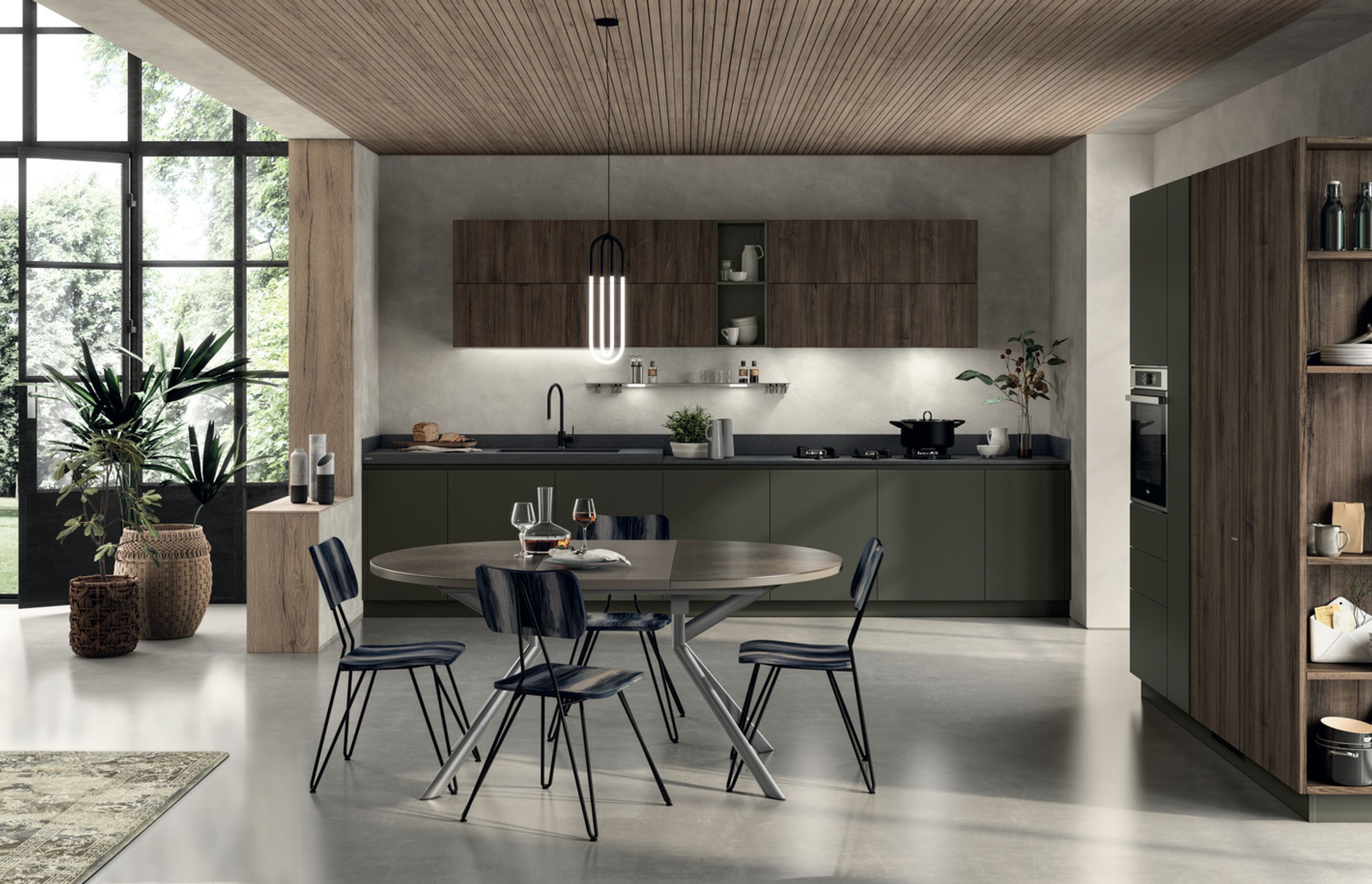 The harmonious appeal of Mineral Green used for the recessed grip profles, base units and plinths constitutes an extremely classy detail: this matt lacquered colour distinguishes the operational areas of the kitchen, and matches the textured feel of Calce Nero Porcelain Stoneware to perfection. The wall units and tall units are in Garden Walnut decorative melamine (with vertical grain).