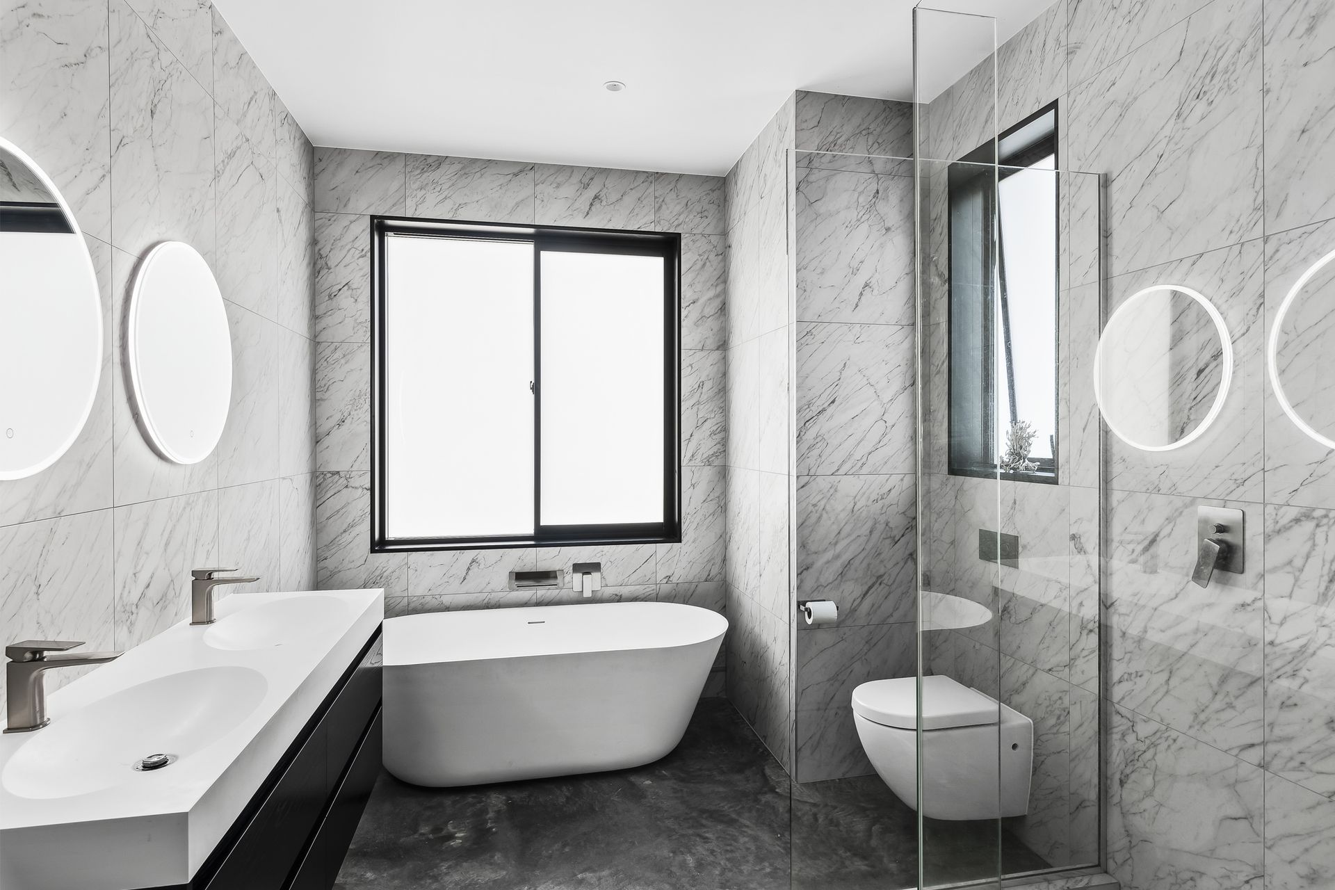 Carrara silver matt tiles and the freestanding bath is Progetto Niagara Ellipse from Plumbline.