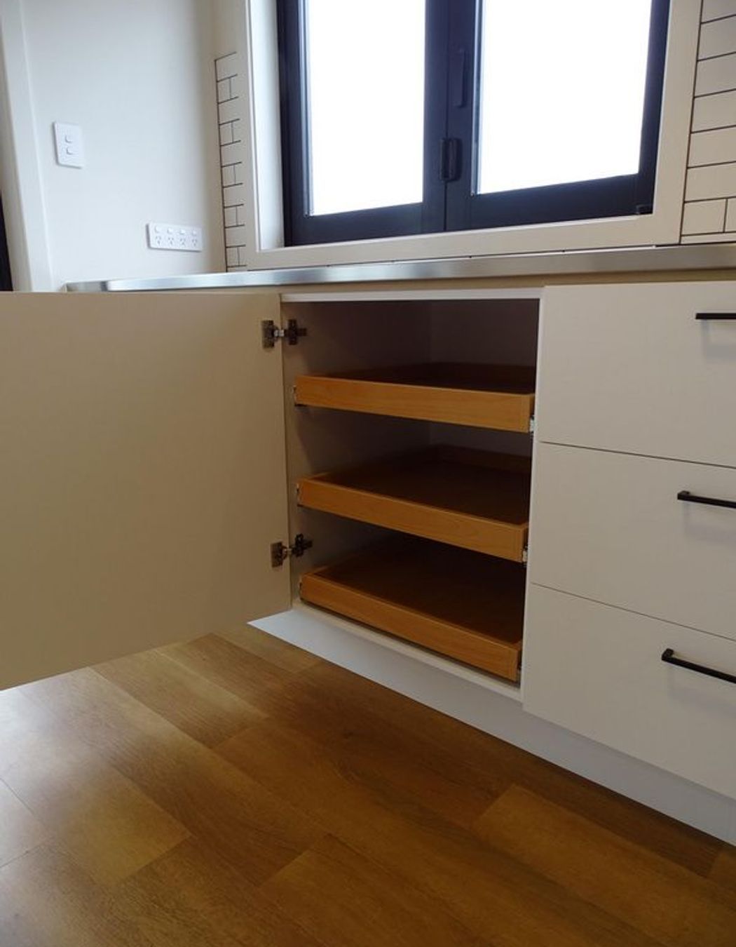 Pull out shelves create a great kitchen storage solution