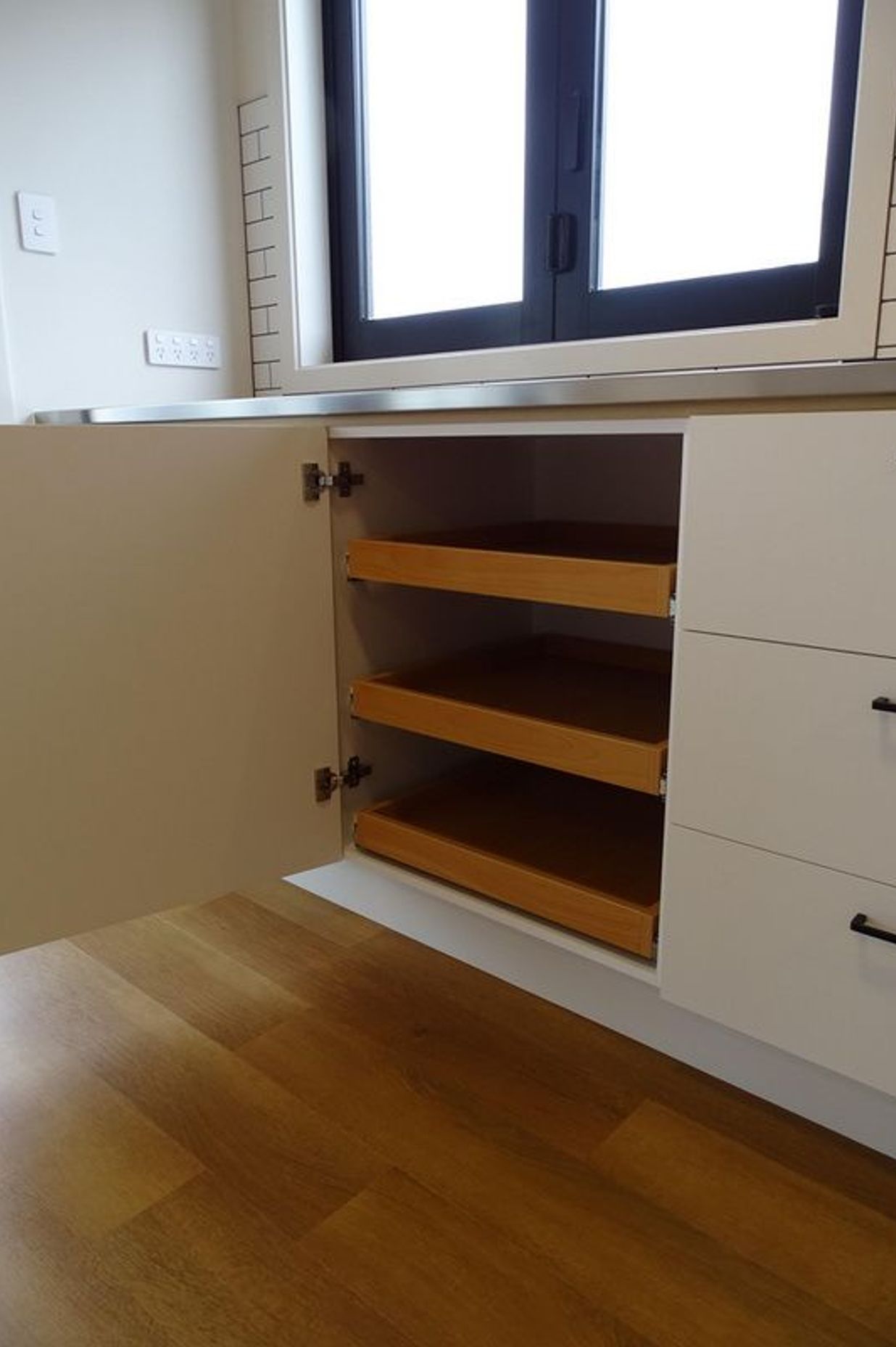 Pull out shelves create a great kitchen storage solution