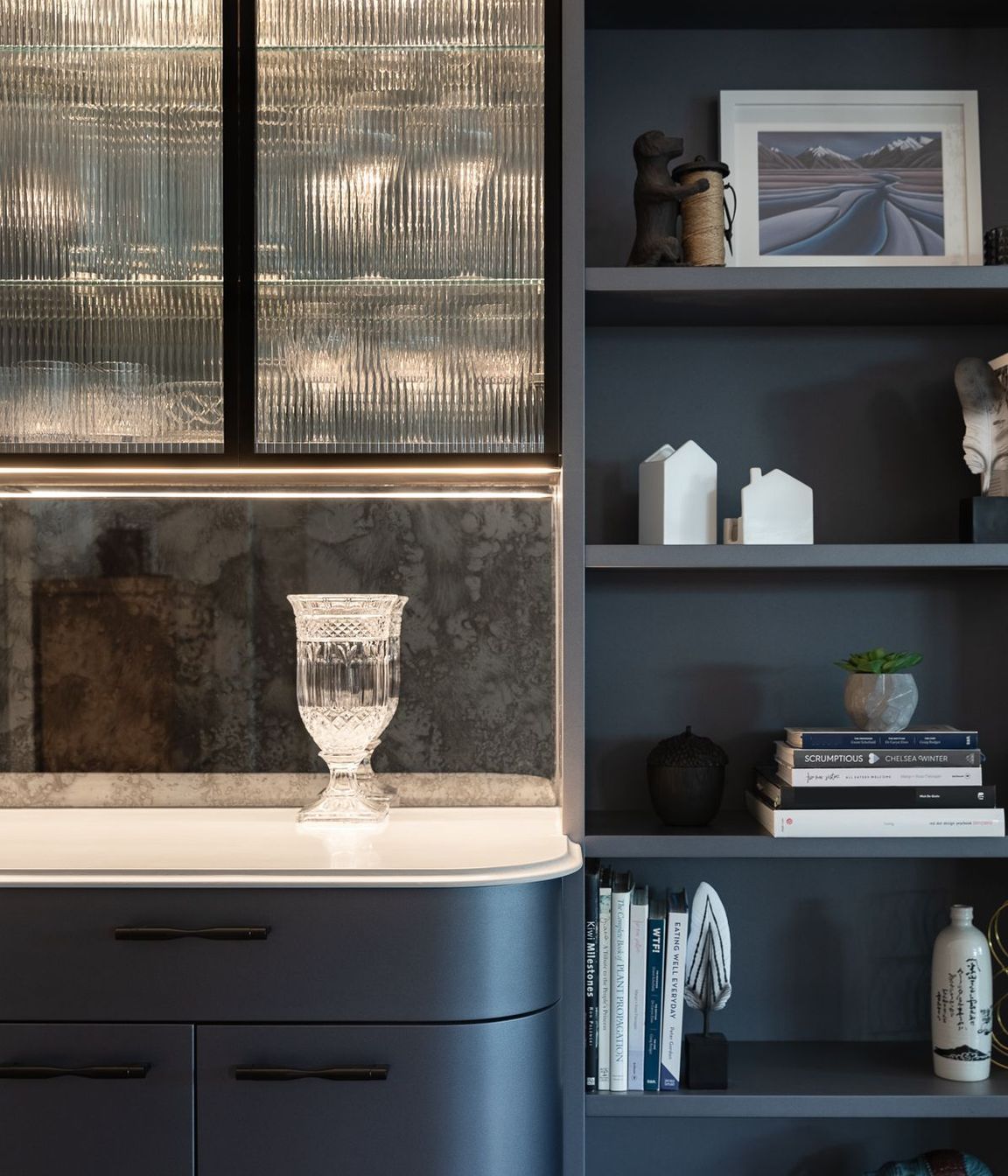Exquisite lines and curated soft lighting completes the sophisticated design. Located opposite the kitchen, the bar leads on to an outdoor entertainment room complete with fireplace, wall heaters, a movie screen and integrated BBQ.