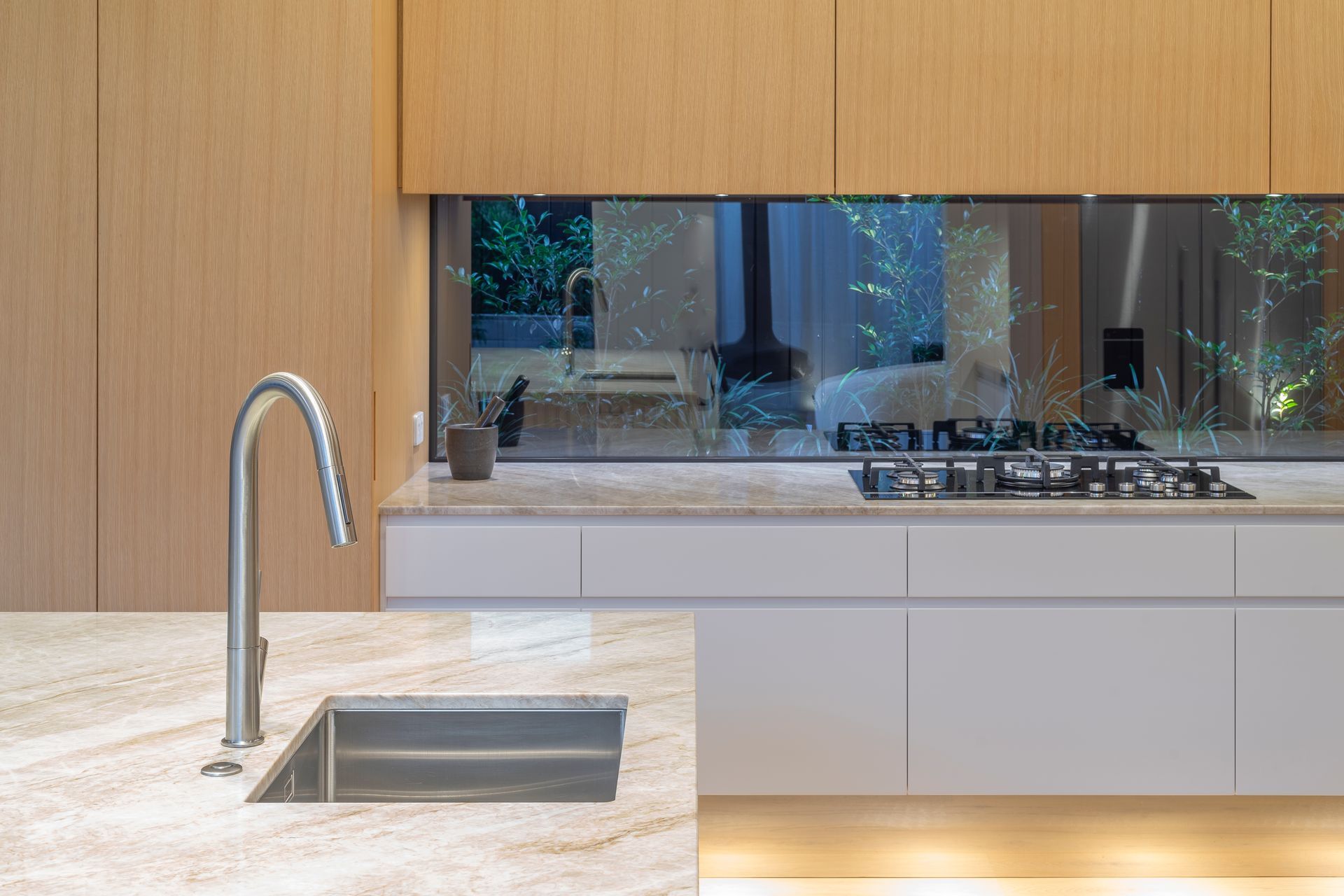 The clients wanted it to feel “like the garden is right there”. Toni designed the 4m bench and three surrounding panels to extend deep into the window jambs - a complex detail created to seamlessly frame their intimate garden beyond.