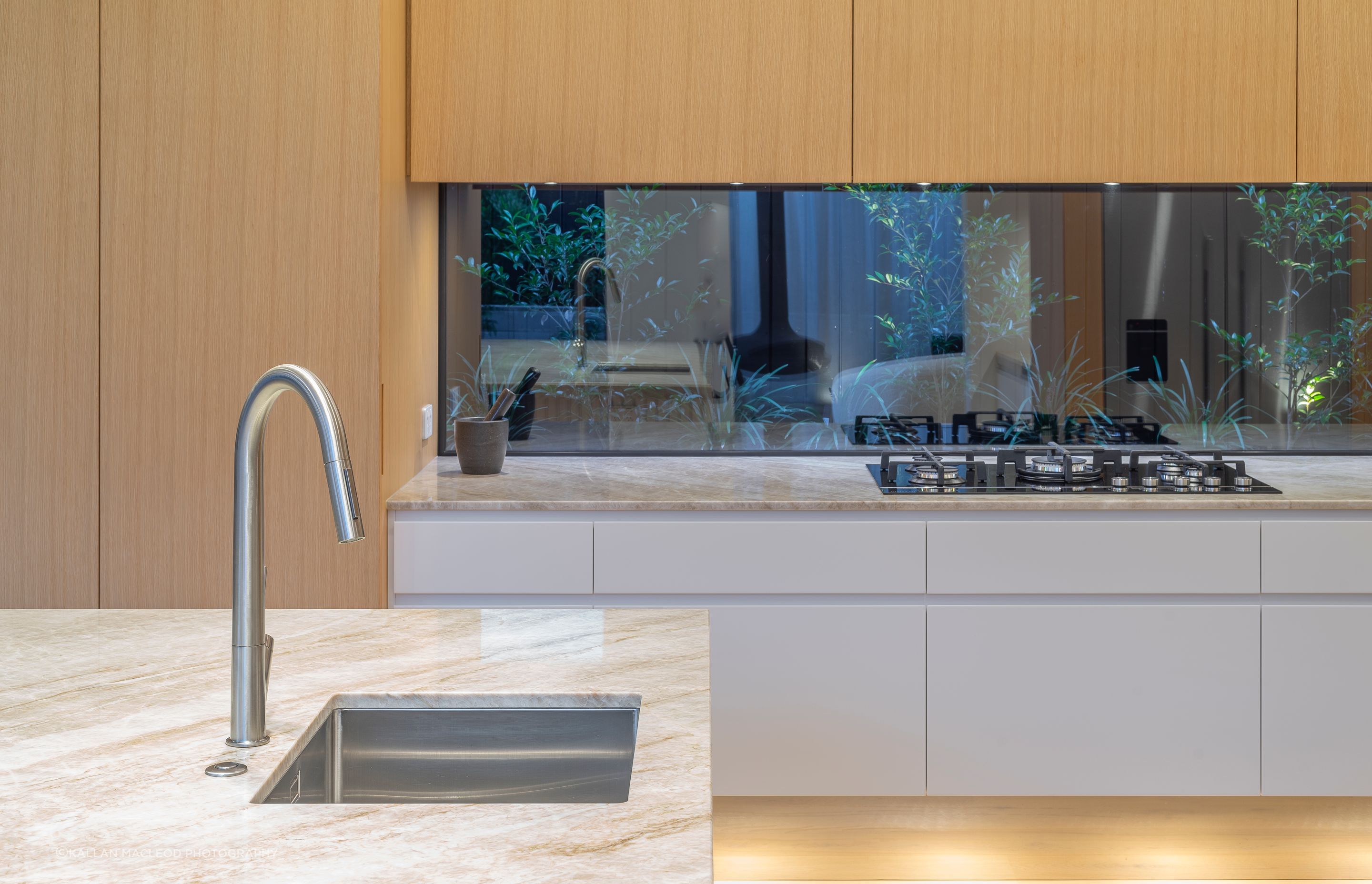 The clients wanted it to feel “like the garden is right there”. Toni designed the 4m bench and three surrounding panels to extend deep into the window jambs - a complex detail created to seamlessly frame their intimate garden beyond.