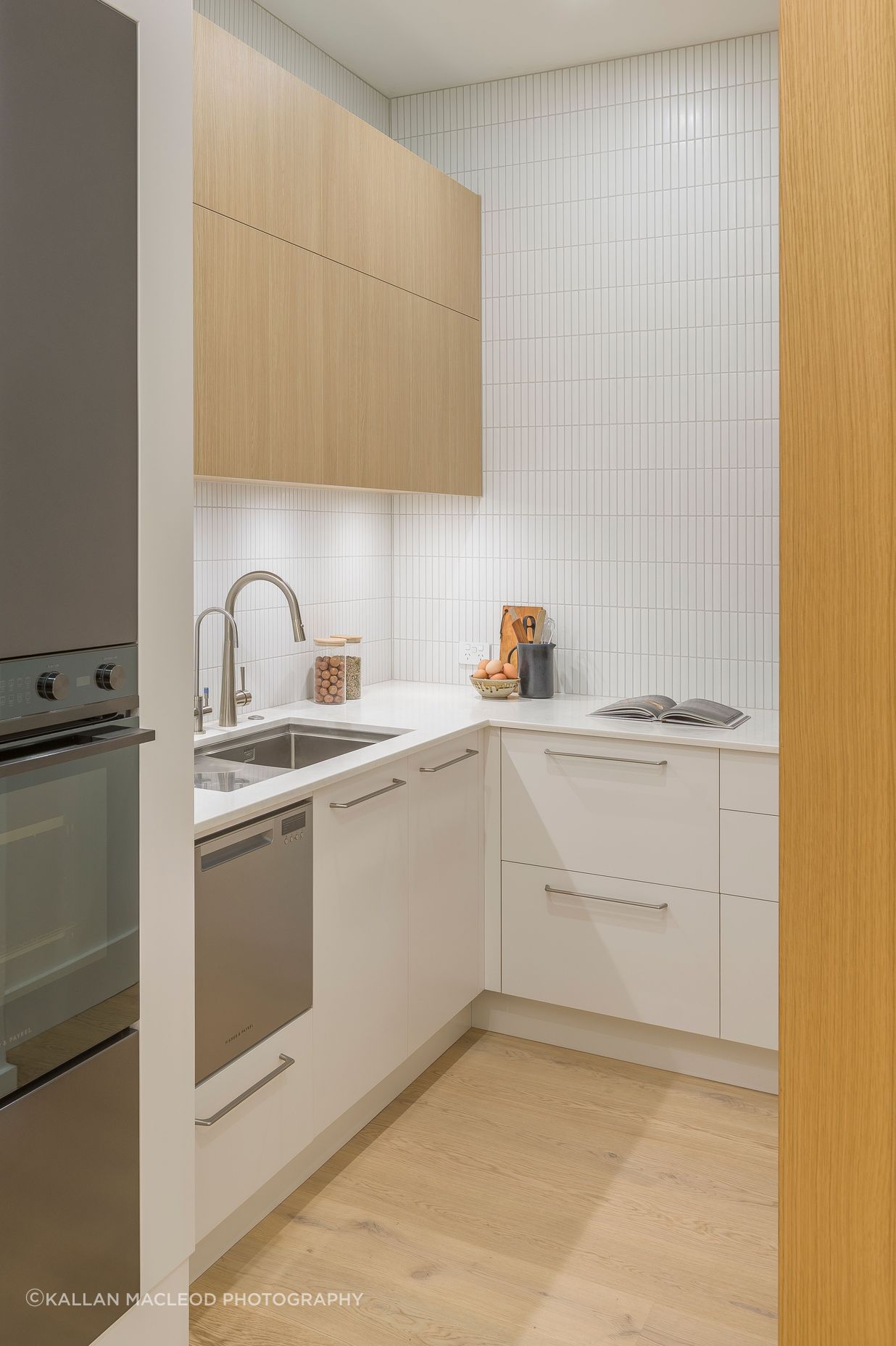 Meeting the client’s wish for the messy functions of baking and juicing, an open scullery is discreetly located behind; fitted with a sparkling chilled water tap and an overflow dishdrawer. Its materiality reiterates the kitchen in highly serviceable yet realistic Melteca surfaces from Laminex.