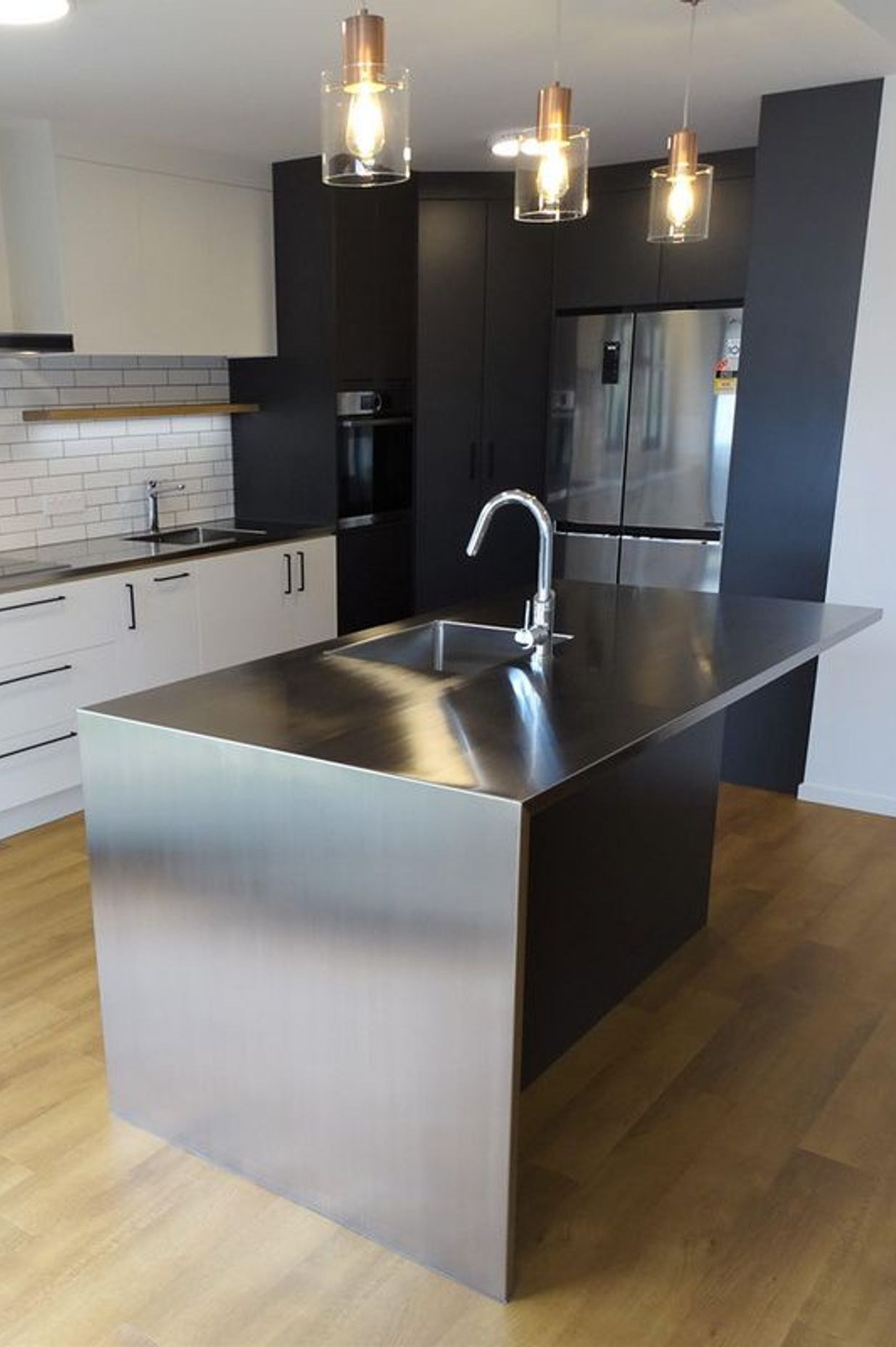 Stainless steel kitchen island with room for breakfast bar seating