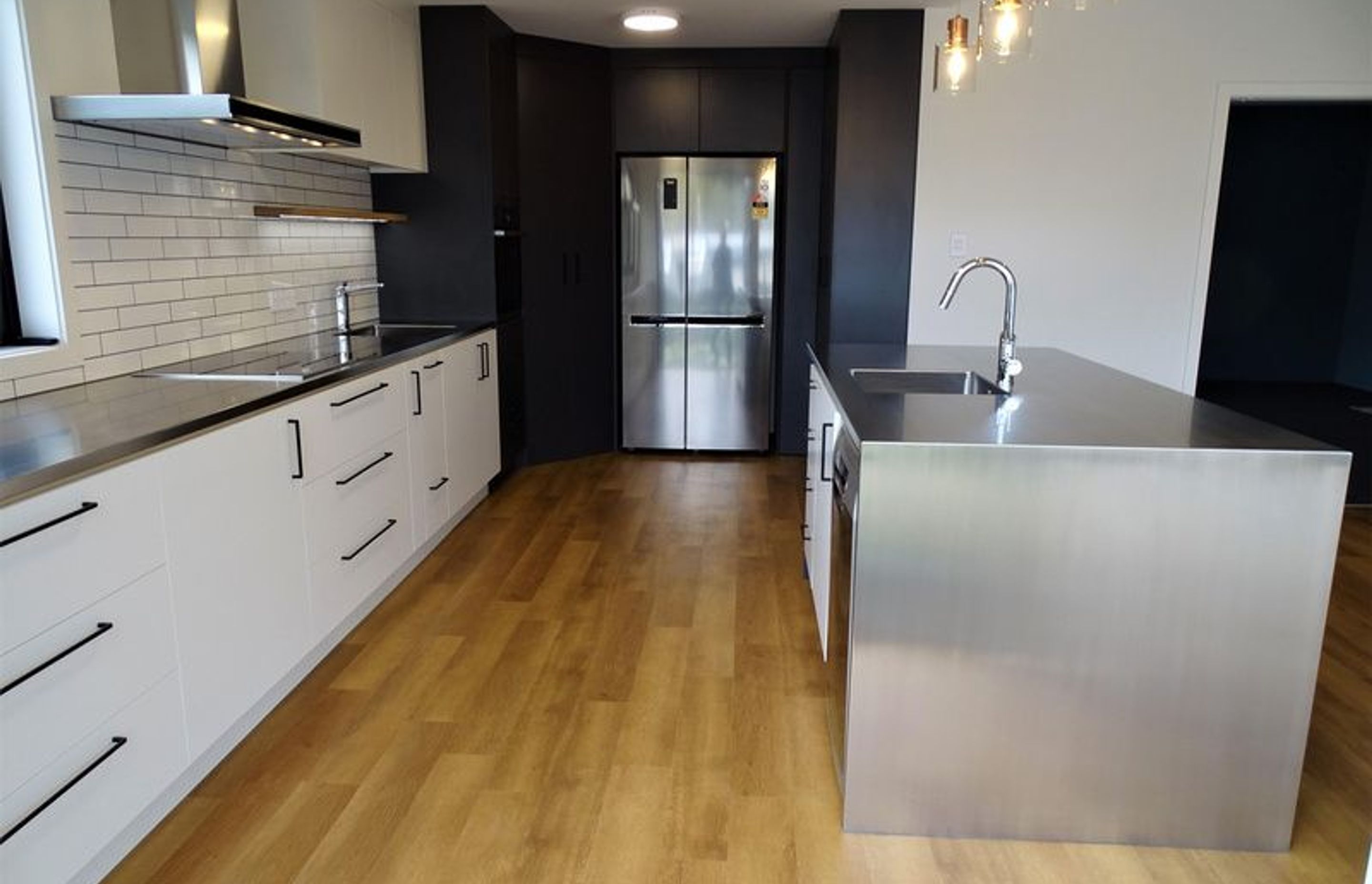 Stainless steel white black and wood make a modern kitchen design
