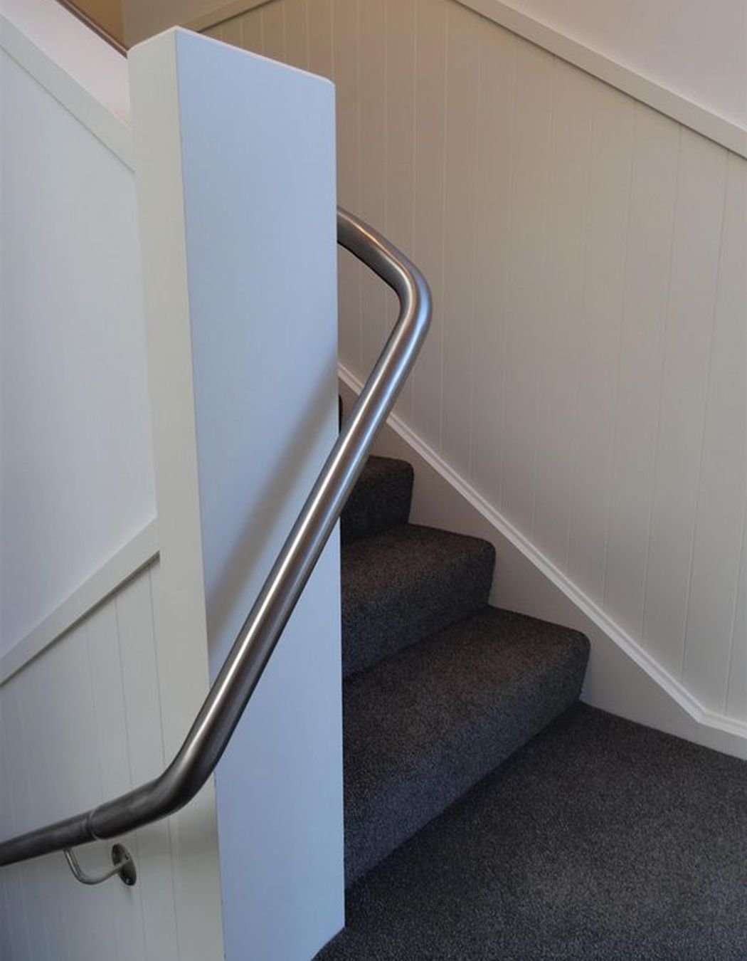 Stairs and handrail going around the corner