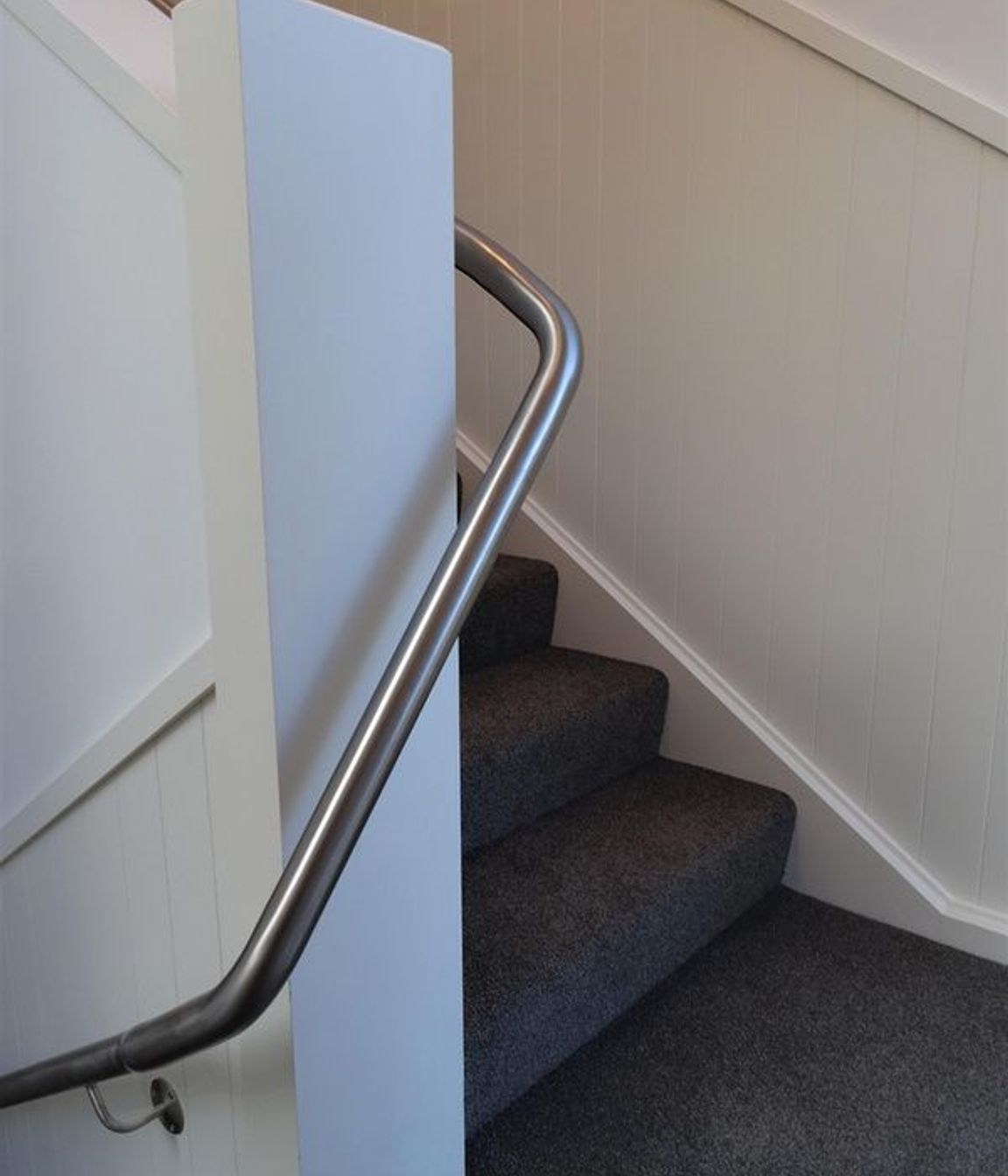 Stairs and handrail going around the corner