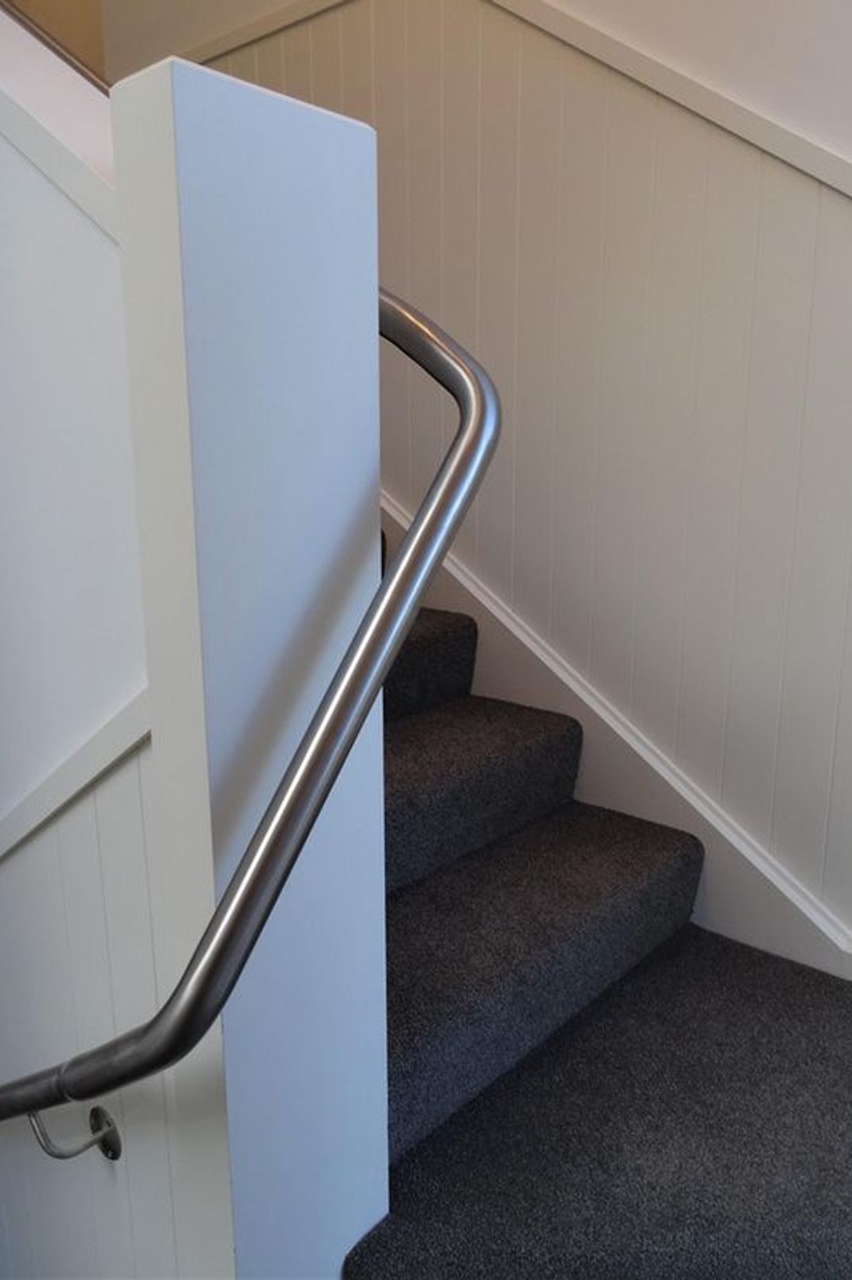 Stairs and handrail going around the corner