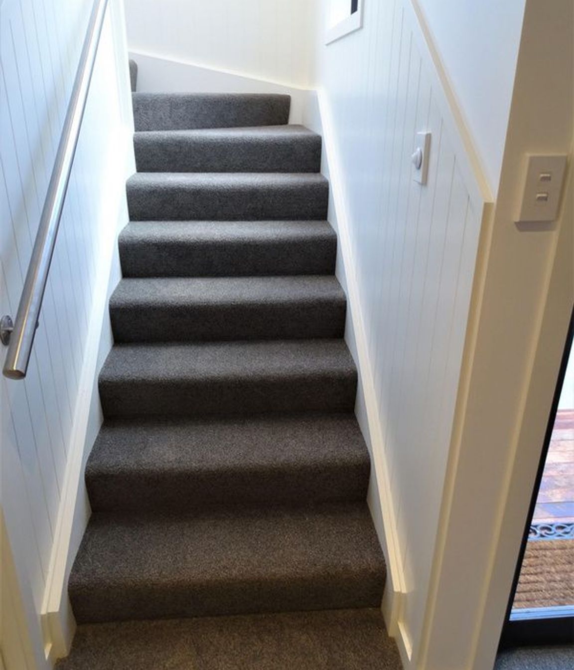 The stairs curve at the top and have wall detailing