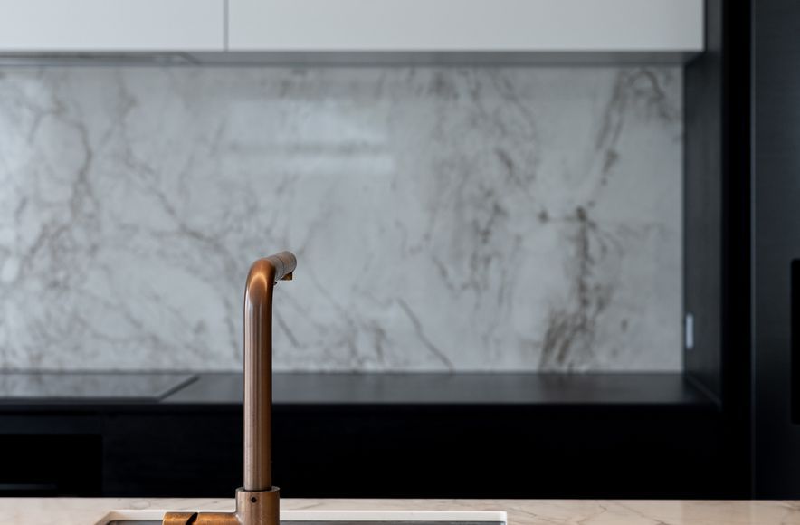 A Contemporary Black Kitchen Features Dekton Bergen