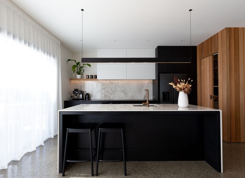 A Contemporary Black Kitchen Features Dekton Bergen