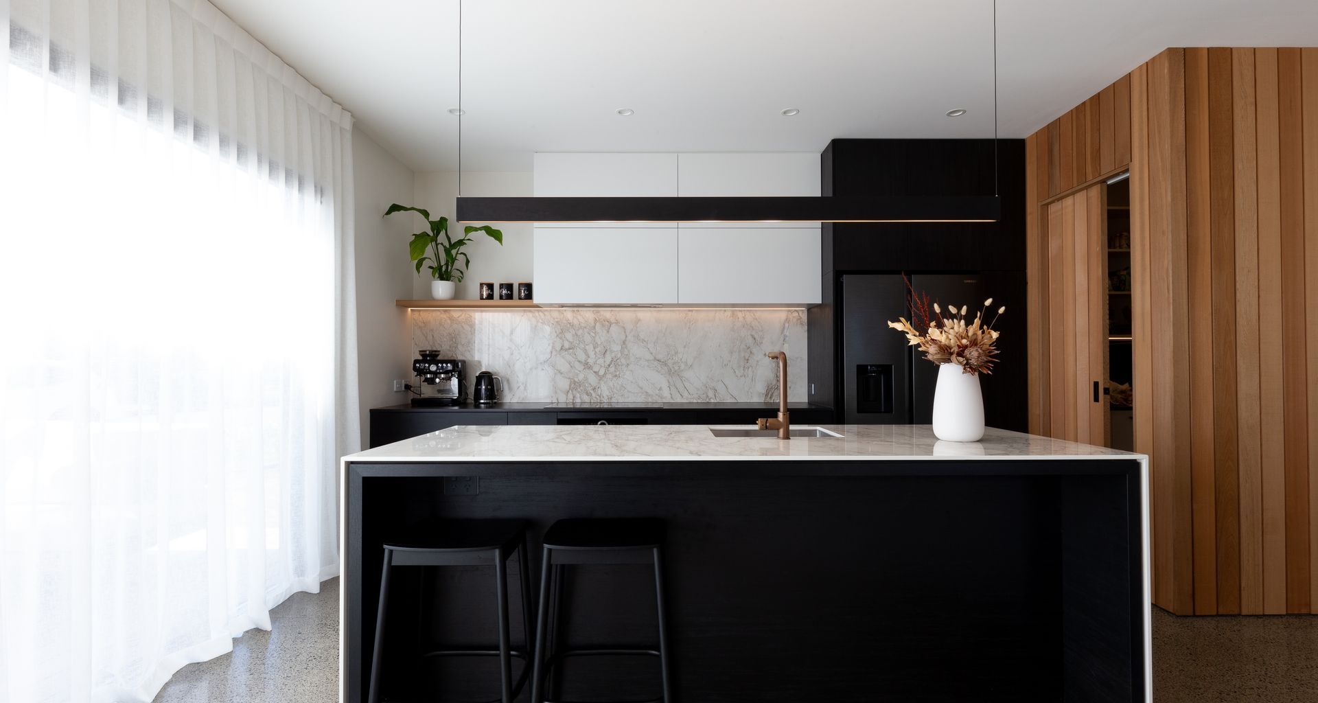 A Contemporary Black Kitchen Features Dekton Bergen banner