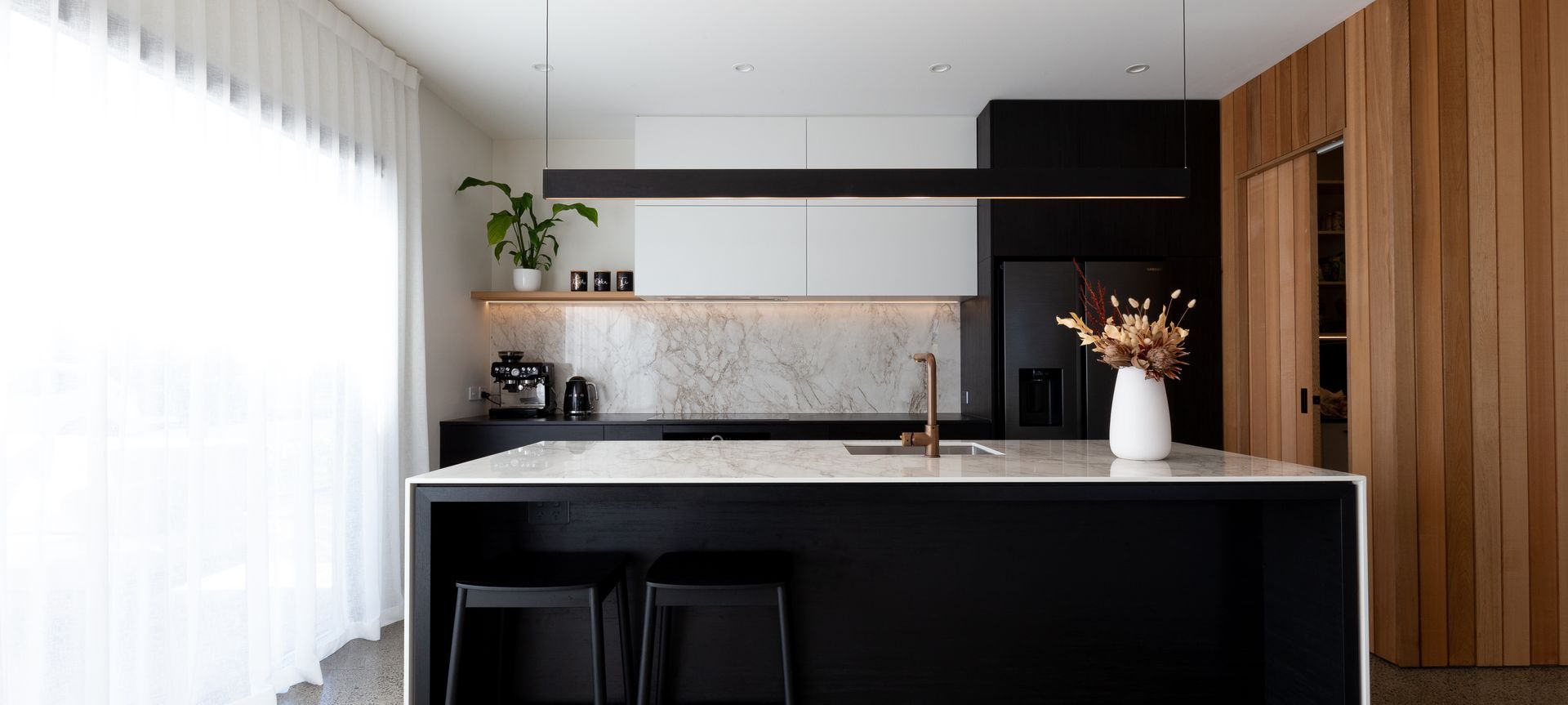 A Contemporary Black Kitchen Features Dekton Bergen banner