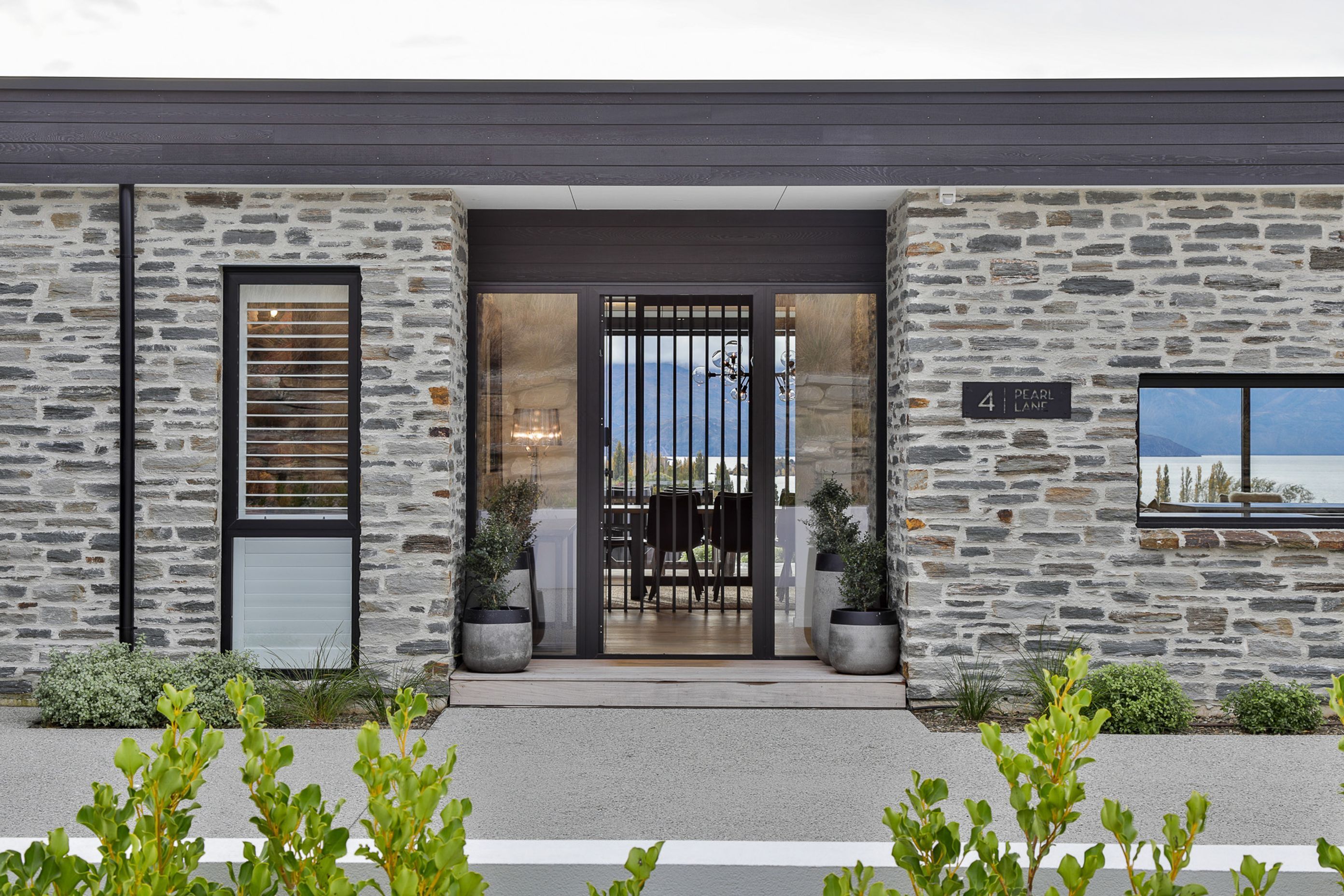 Schist exterior cladding and entrance.  Landscaping- by Tim at The Landscaper Wanaka.