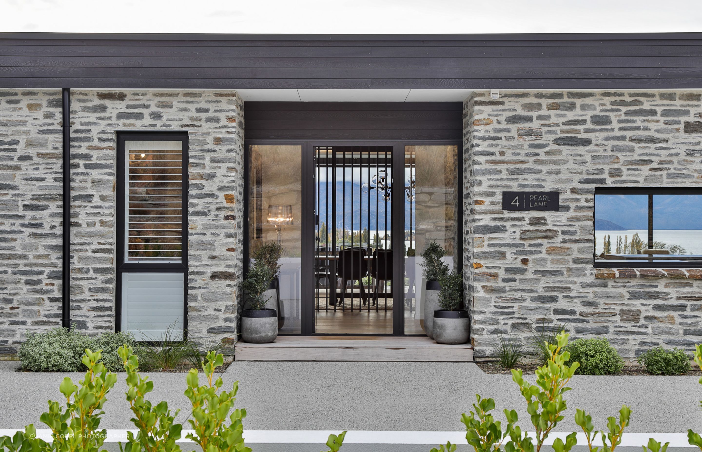 Schist exterior cladding and entrance. Landscaping- by Tim at The Landscaper Wanaka.