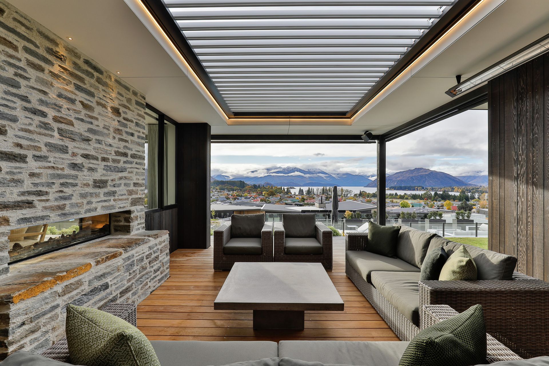 Outdoor Living Room with louvres overhead and ceiling mounted directional heaters.  Interior Design- Kelly @ Archi Build Ltd.