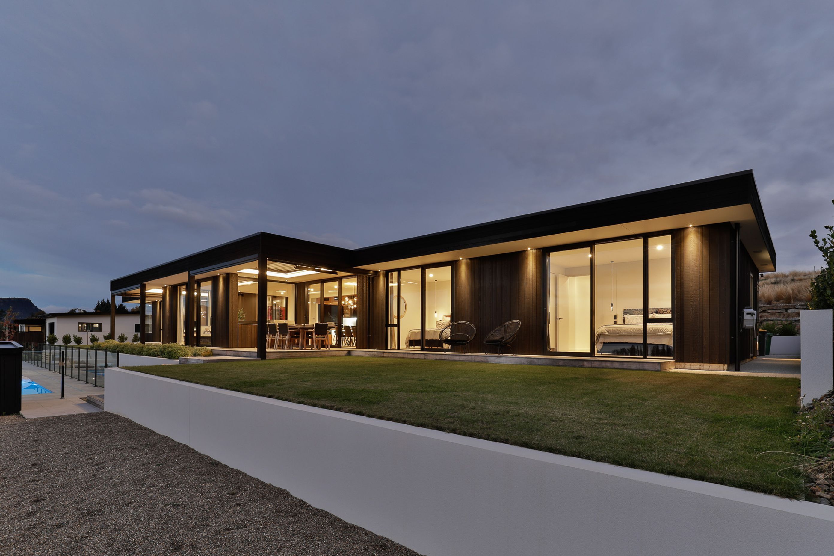 Exterior by night- Guest bedrooms wing.  Interior Design- Kelly @ Archi Build Ltd.