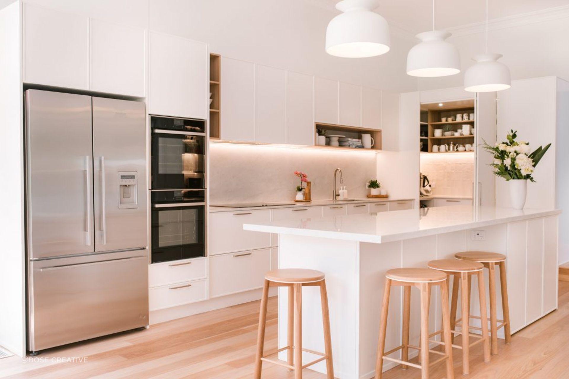 kitchen-design-sydney-luxury-kitchen-white-stone-bench-timber-floor-ornate-doors-pantry-1084x721.jpg