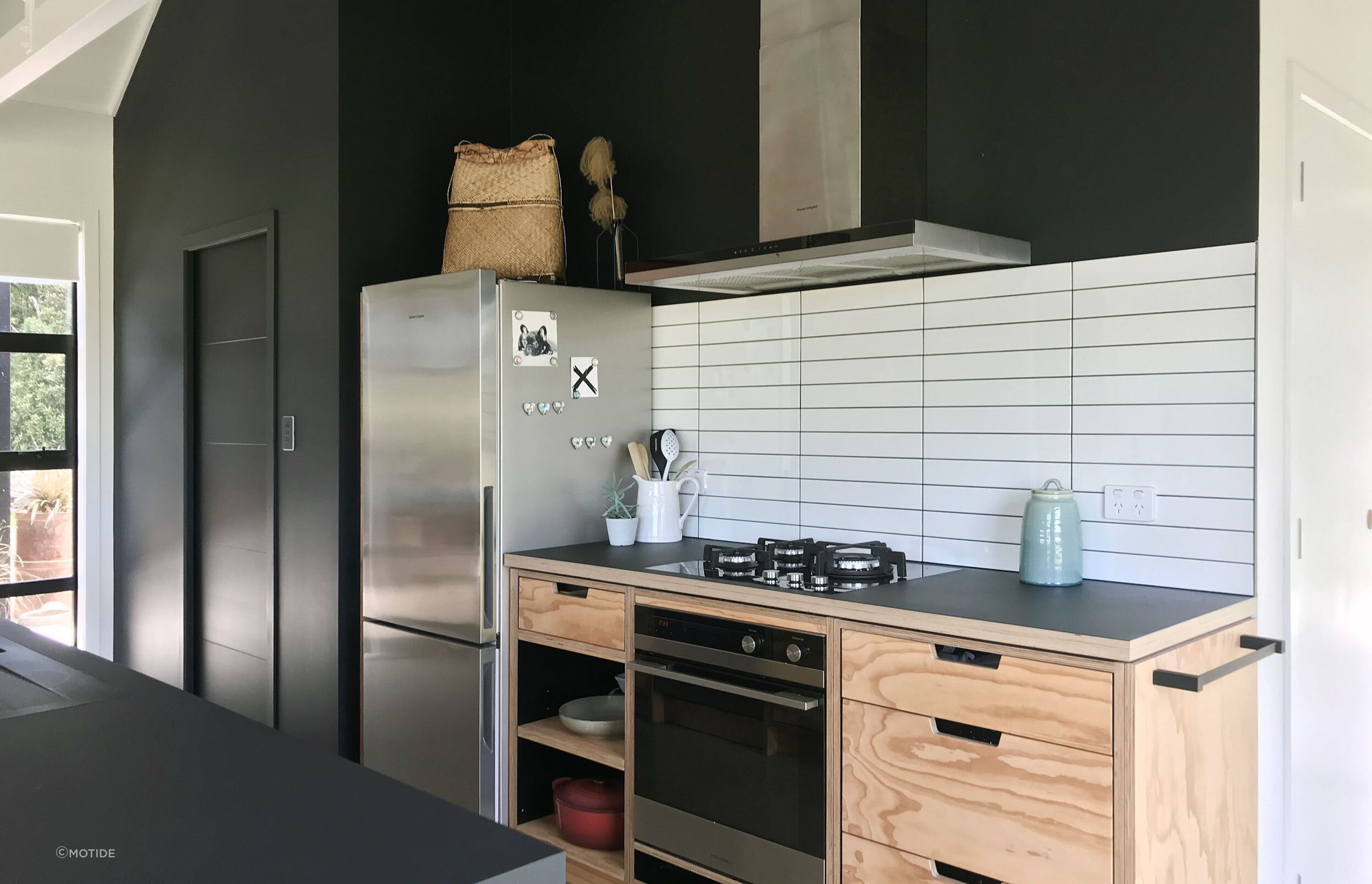 An Elegant Black and Natural Plywood Kitchen