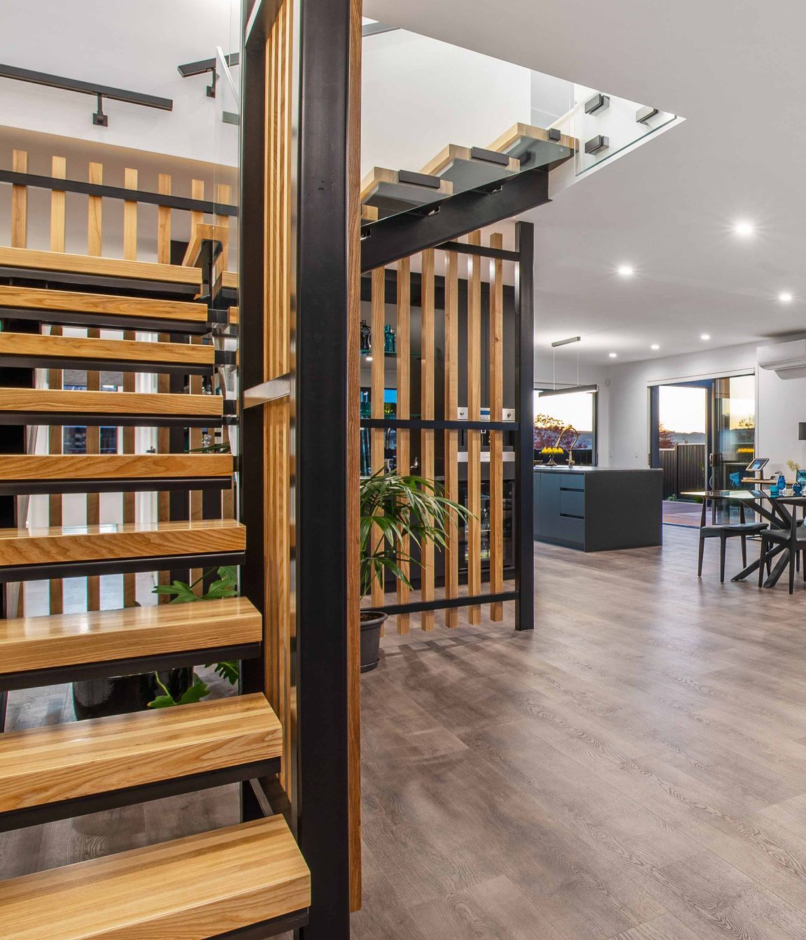 A sculptural, black powder coated steel staircase with American white ash treads and screening is a bold and eye-catching feature.