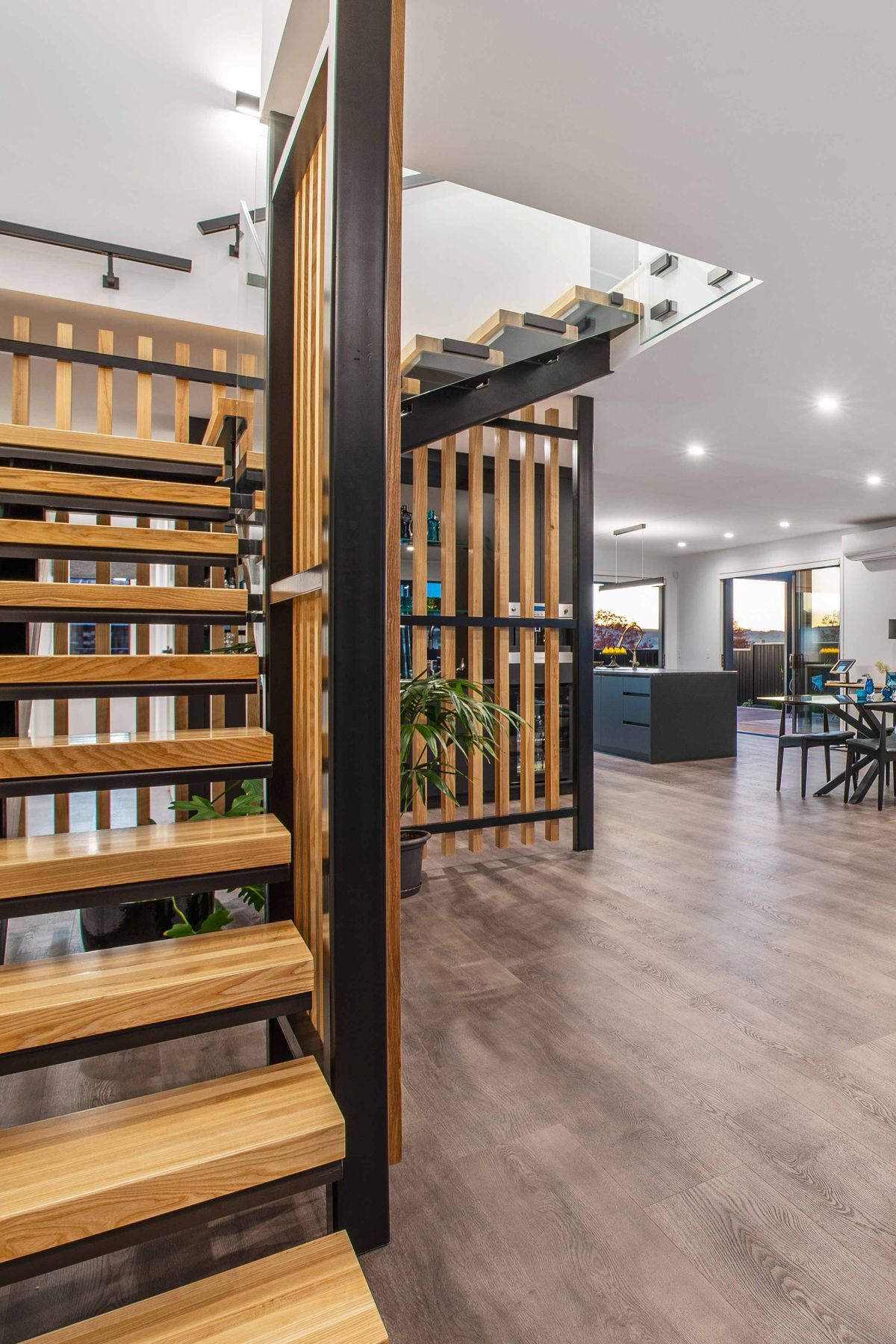 A sculptural, black powder coated steel staircase with American white ash treads and screening is a bold and eye-catching feature.