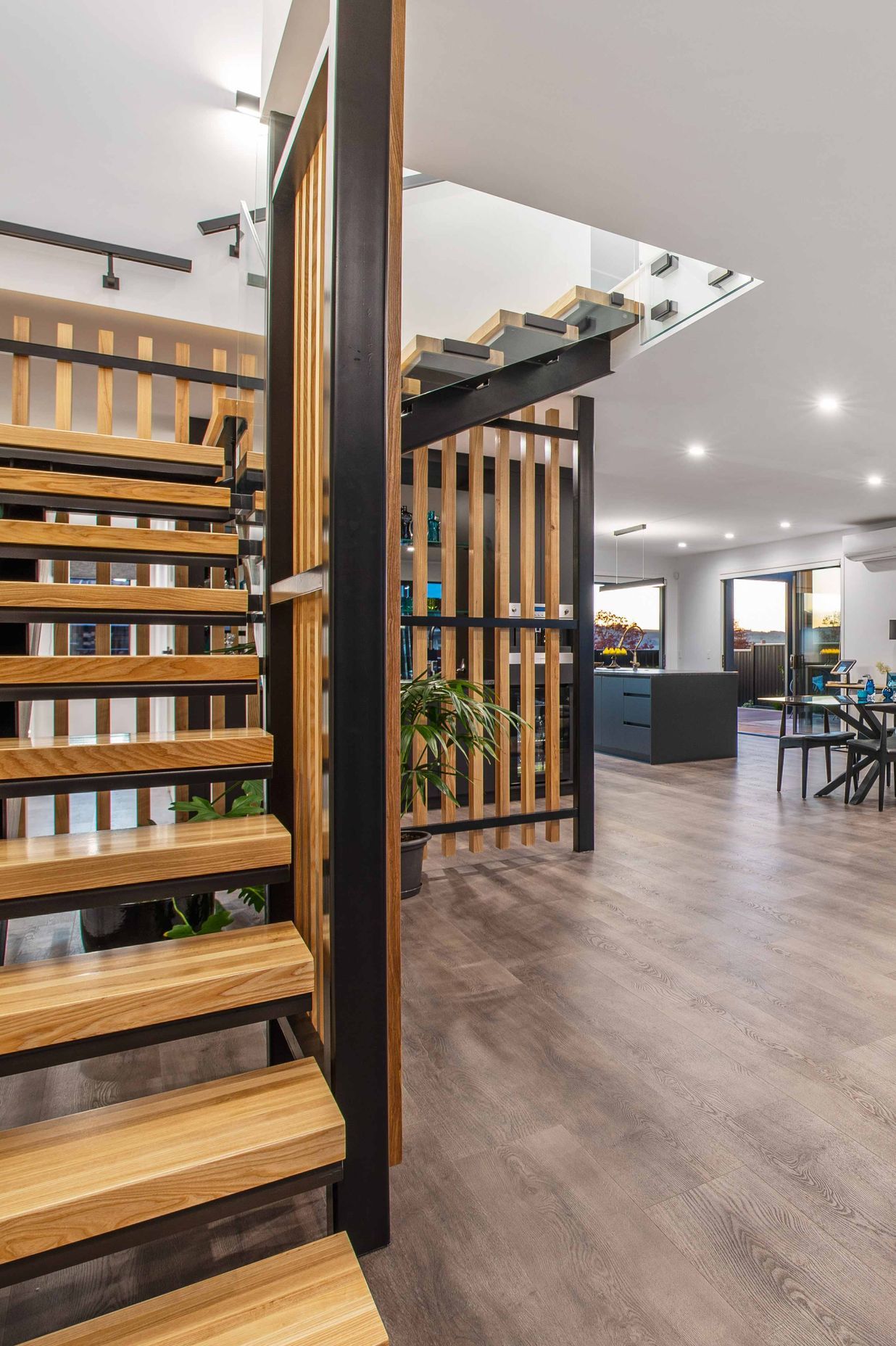 A sculptural, black powder coated steel staircase with American white ash treads and screening is a bold and eye-catching feature.