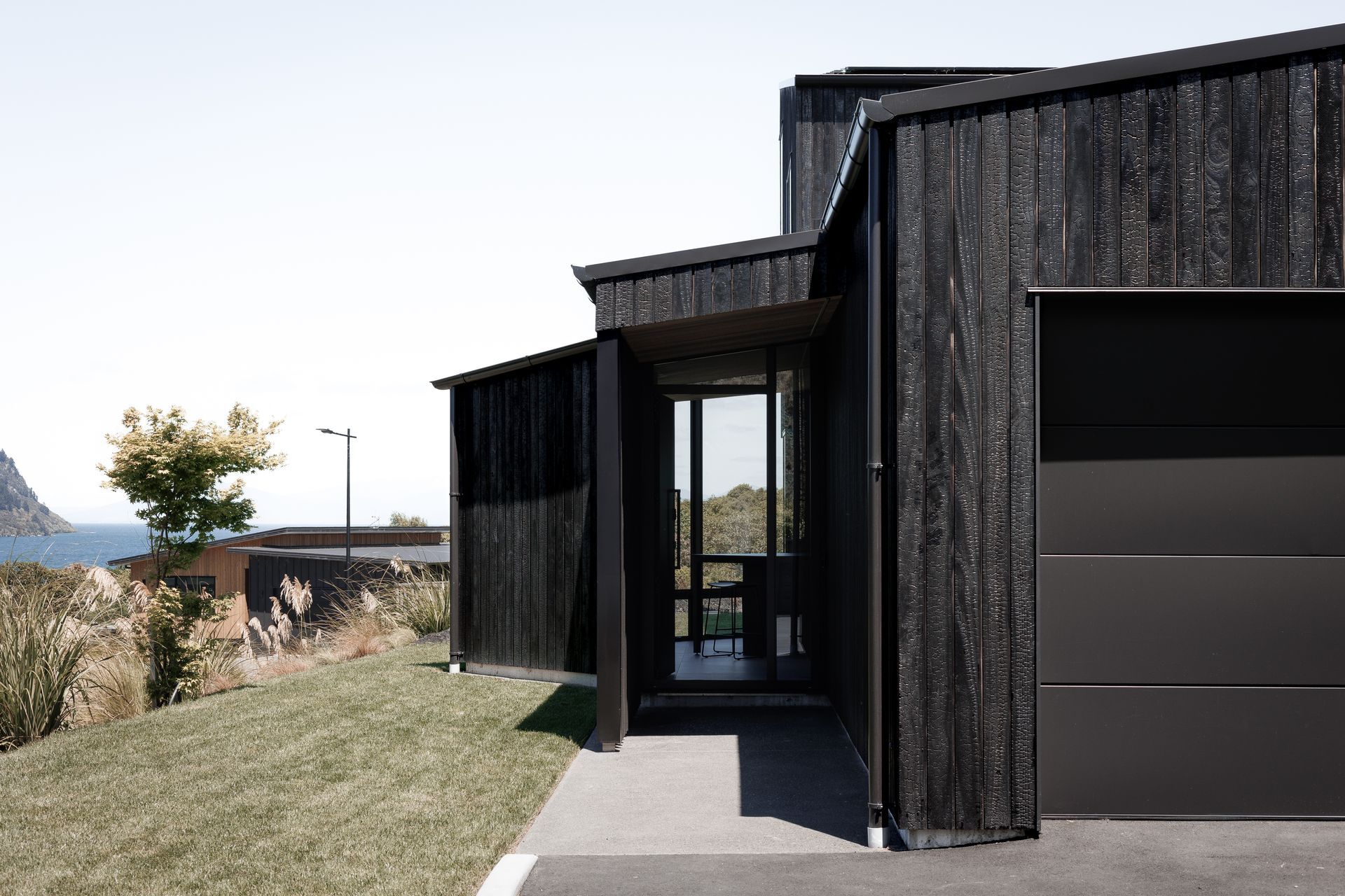 The Kinloch Retreat's kitchen/dining pavilion is angled to frame &amp; connect to Lake Taupō beyond