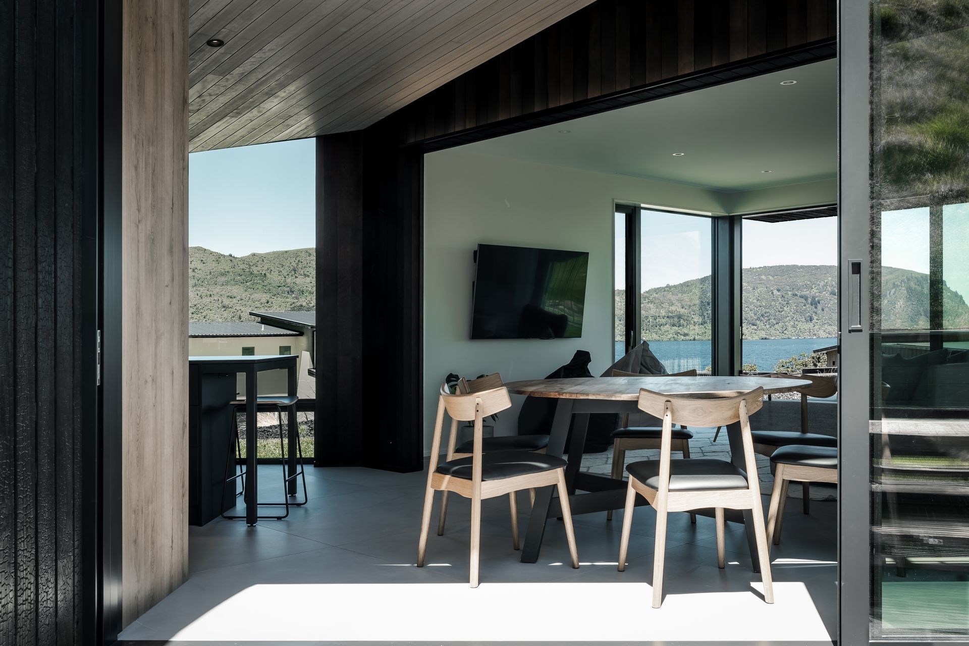 The Kinloch Retreat's kitchen/dining pavilion is angled to frame &amp; connect to Lake Taupō beyond