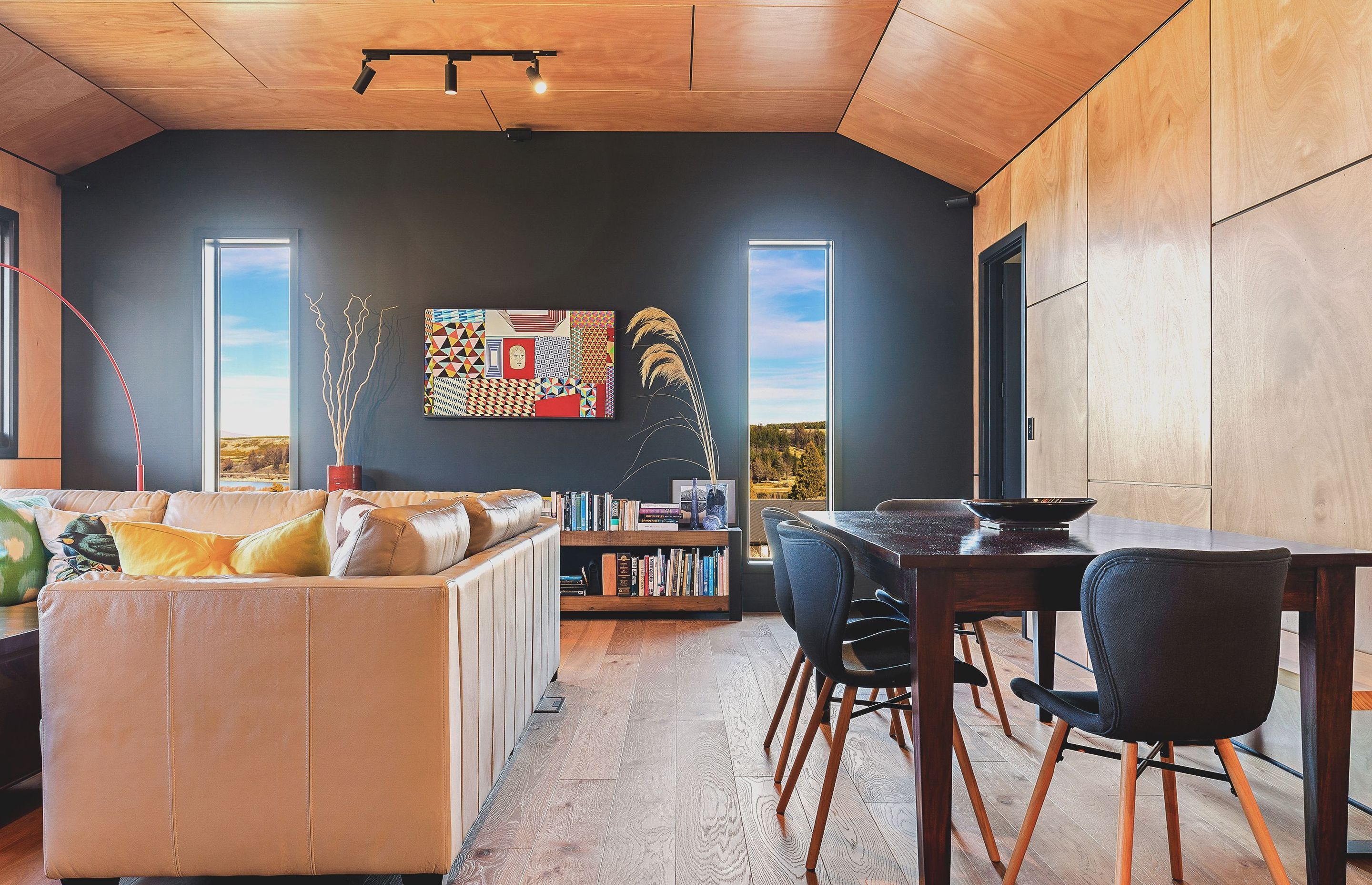 Homeowners planned the footprint around furniture they already owned, including the dining table and a sofa from Gascoigne Furniture which has been decorated with a huia scatter cushion from Spotlight.