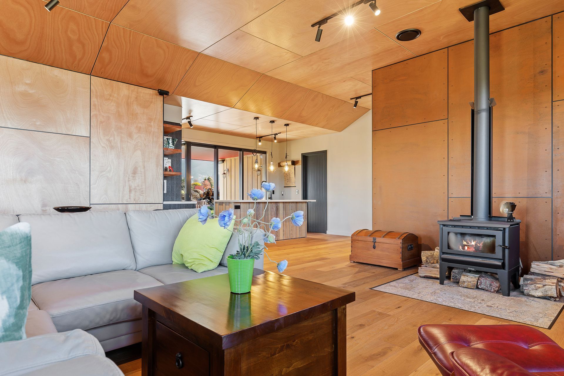 Furned oak floors from Germany team with the walls and ceiling panelled in okoume plywood to ensure a warm aesthetic in the living zones.