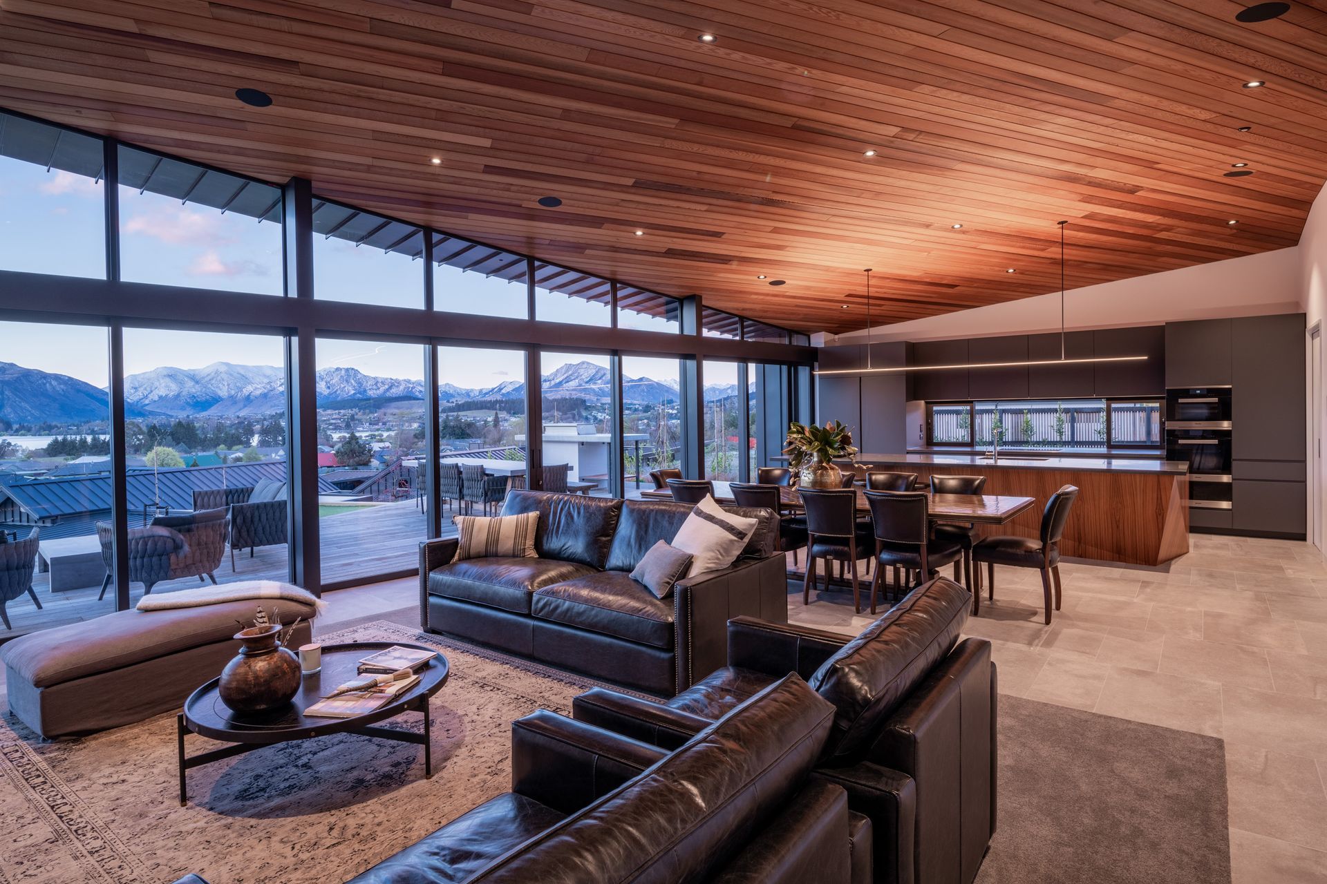 The ceiling and kitchen island feature timber, which has the effect of warming the space.